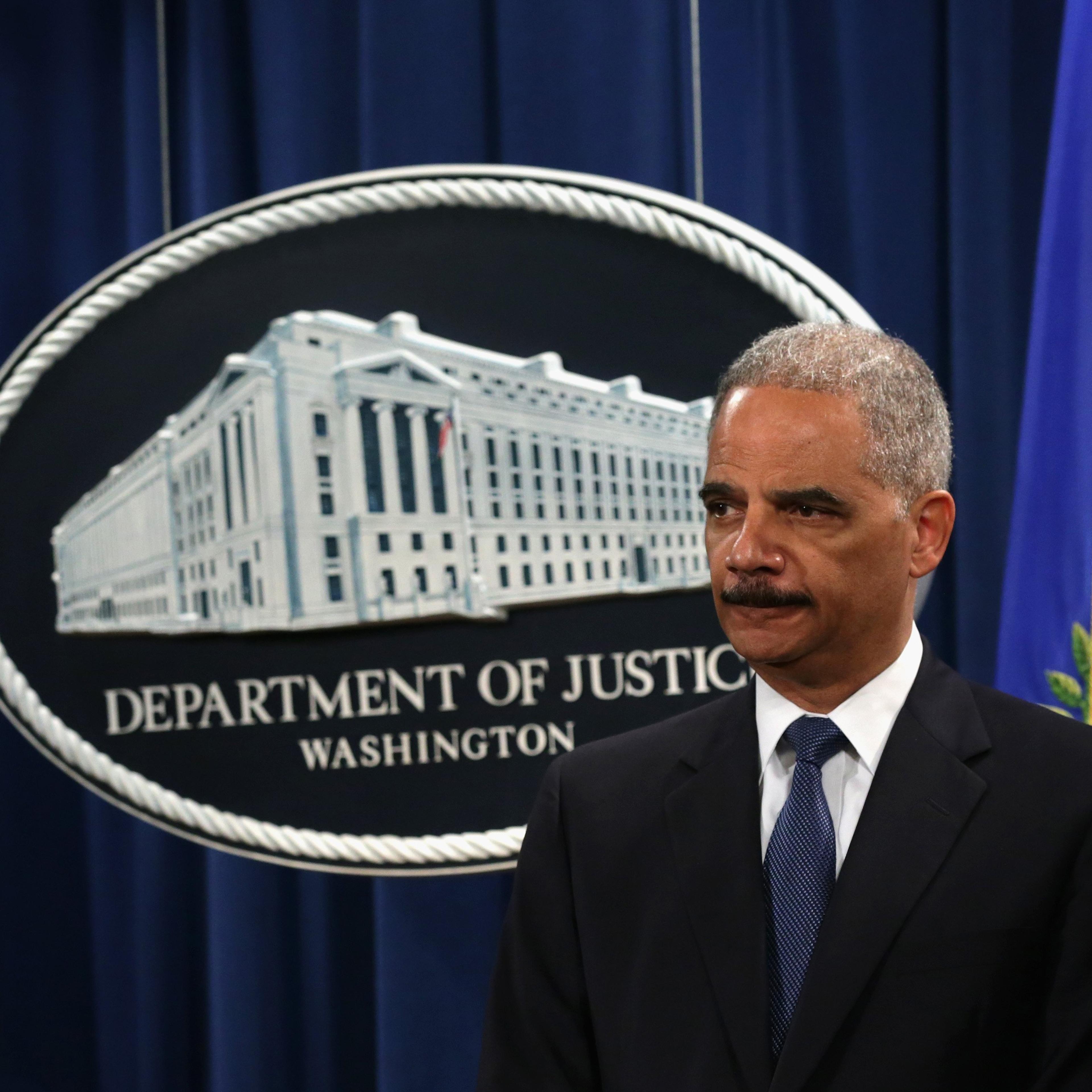Attorney General Eric Holder listens during a news conference to announce indictments against Chinese military hackers on cyber-espionage May 19, 2014 at the Department of Justice in Washington, DC.
