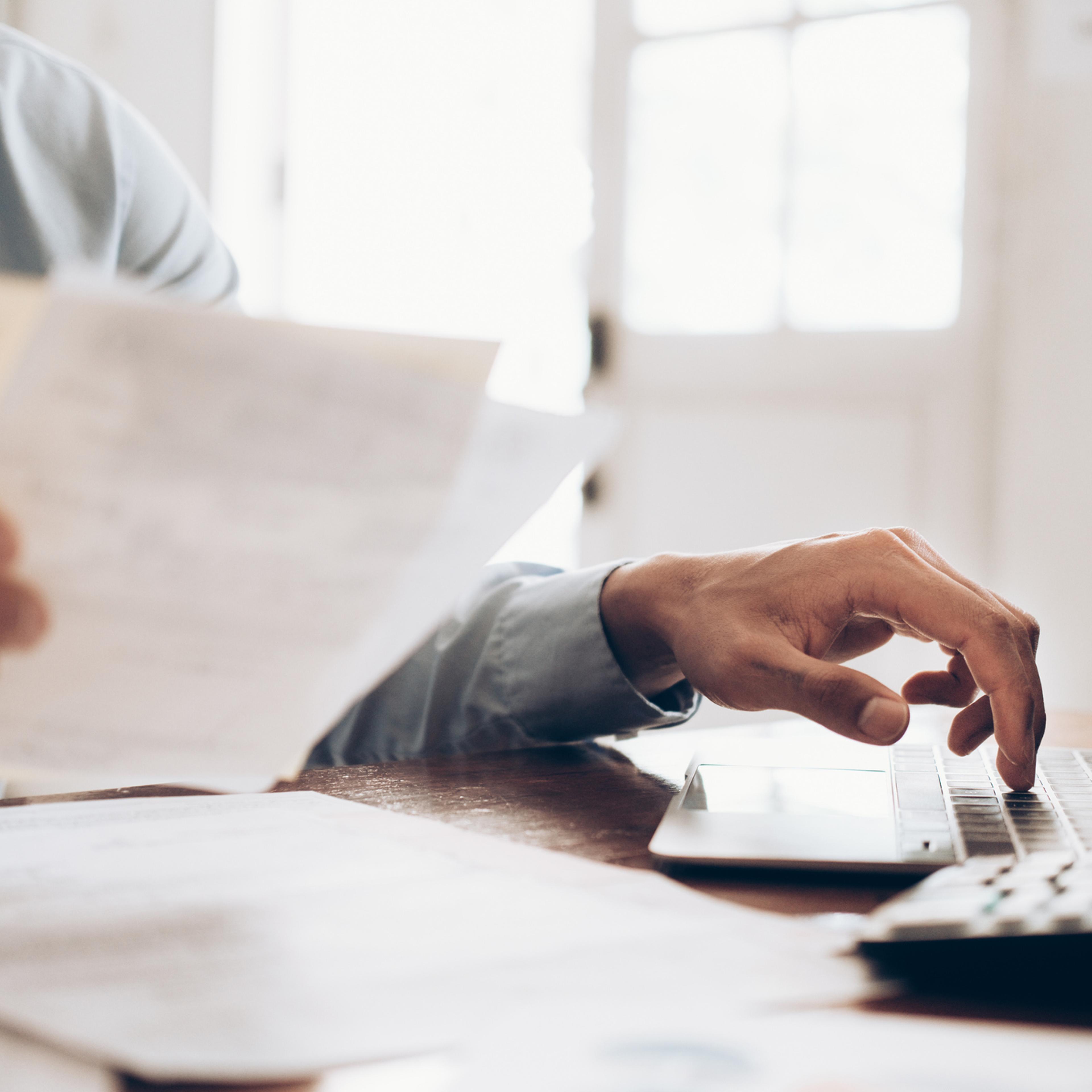 Male accountant or banker use calculator.