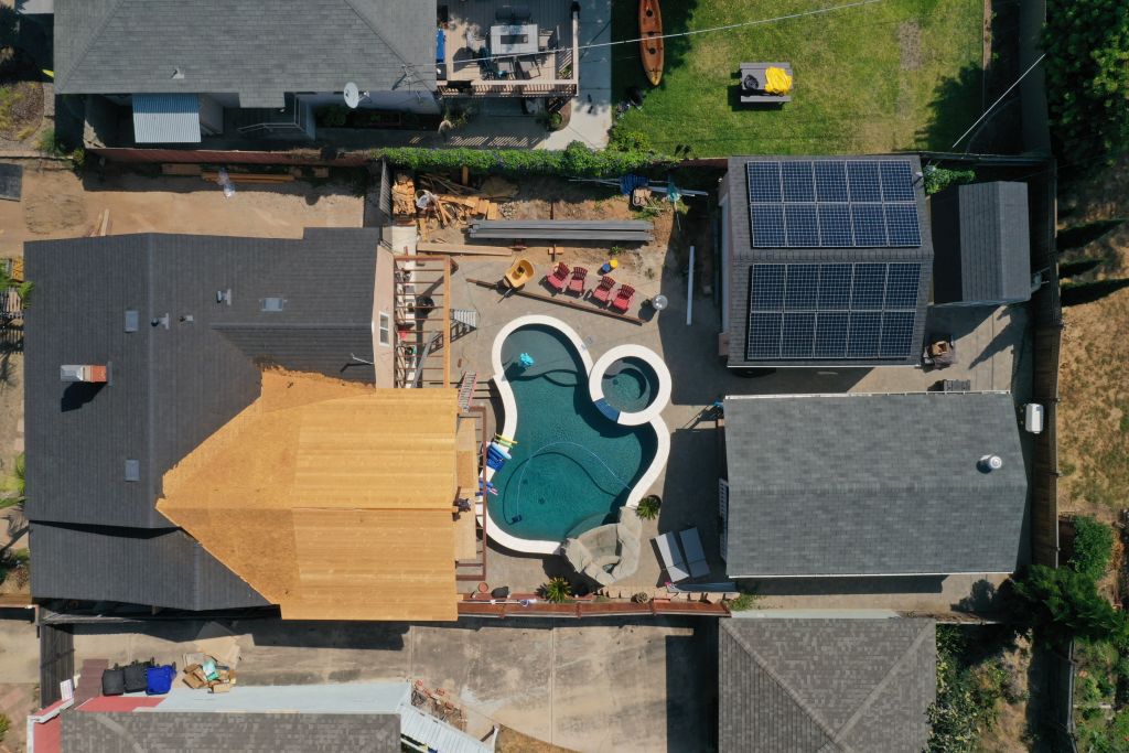 A home with a backyard pool and rooftop solar panels under construction in this aerial photograph taken over the Pacific Beach neighborhood of San Diego.