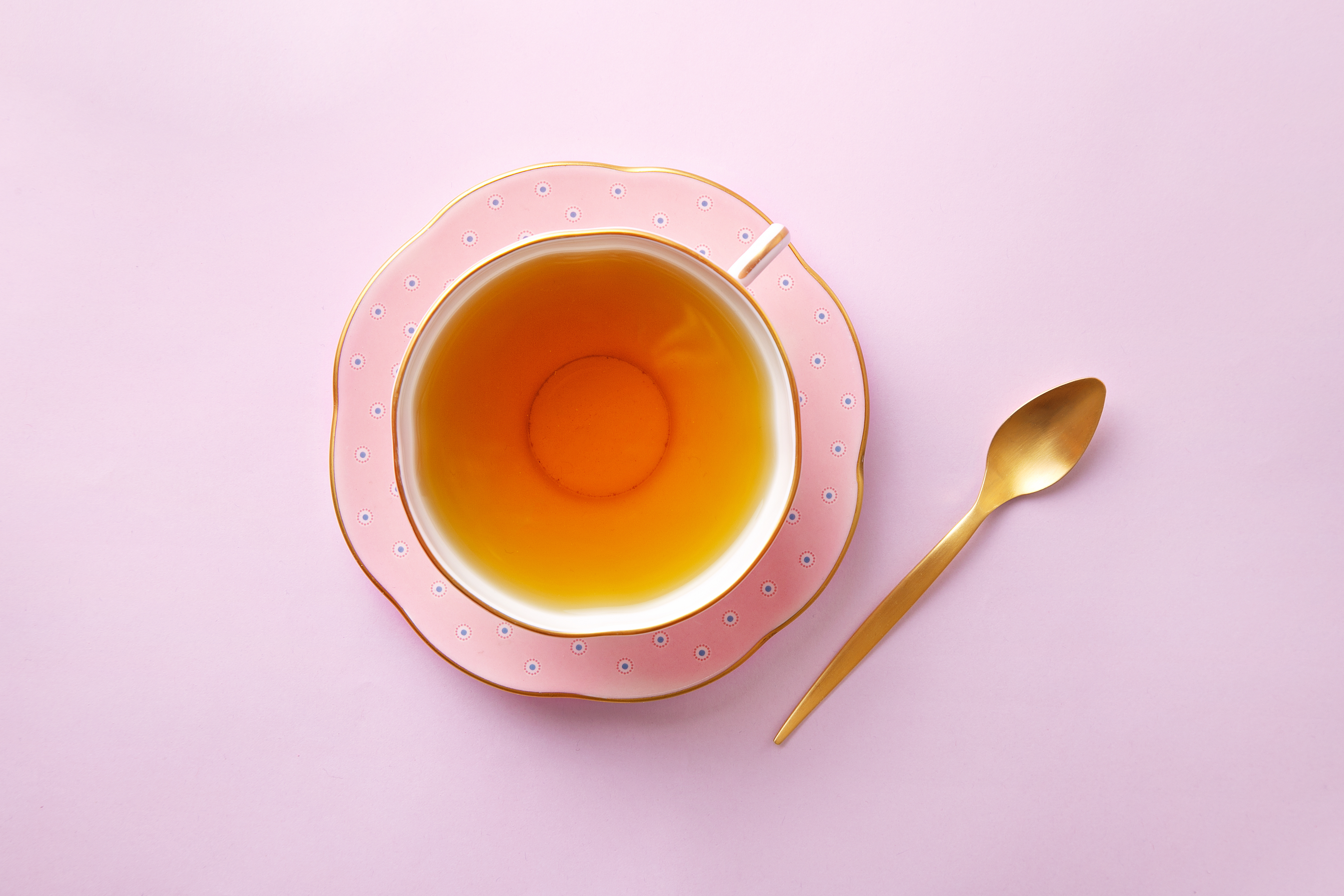Directly Above Shot Of Tea In Cup On Pink Background