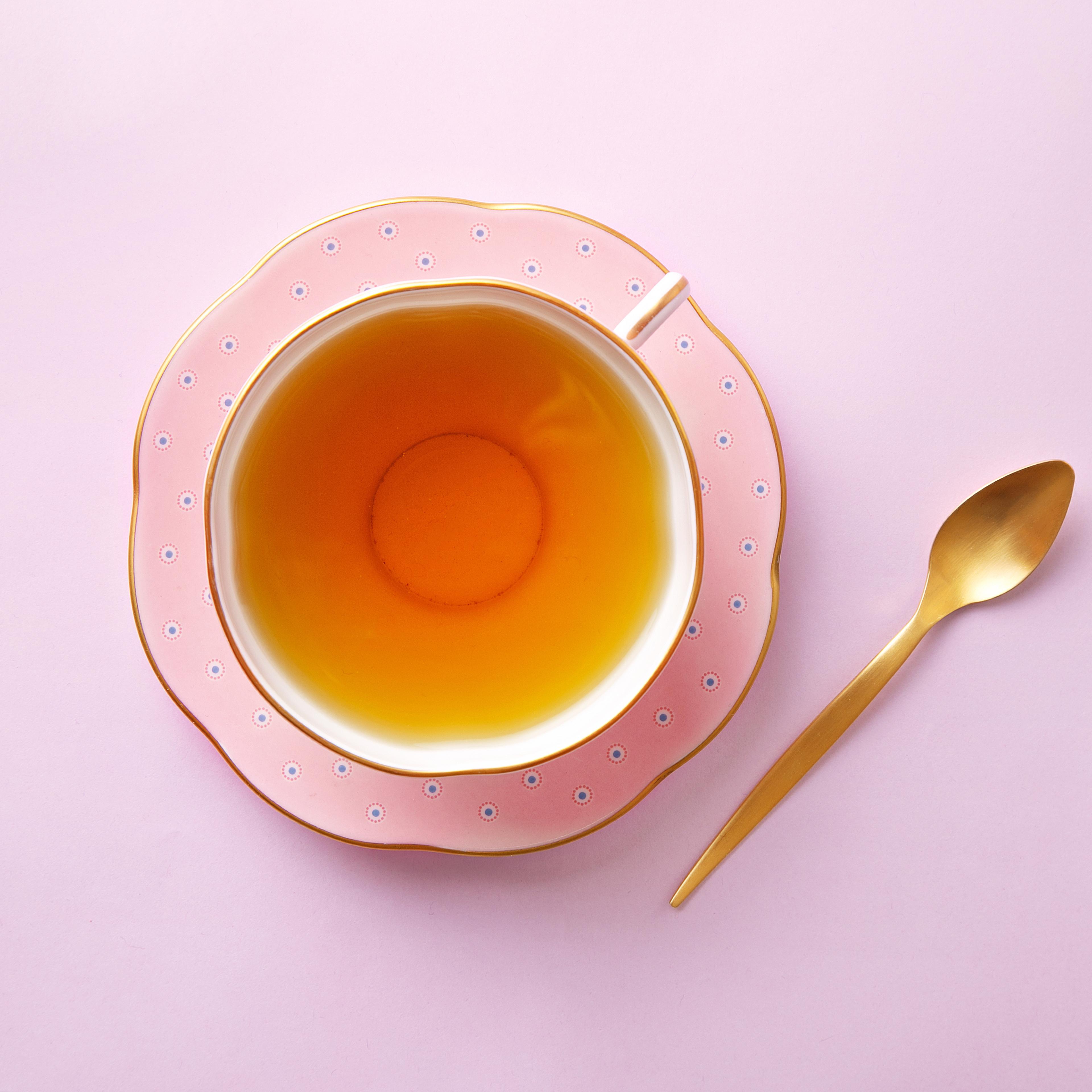 Directly Above Shot Of Tea In Cup On Pink Background
