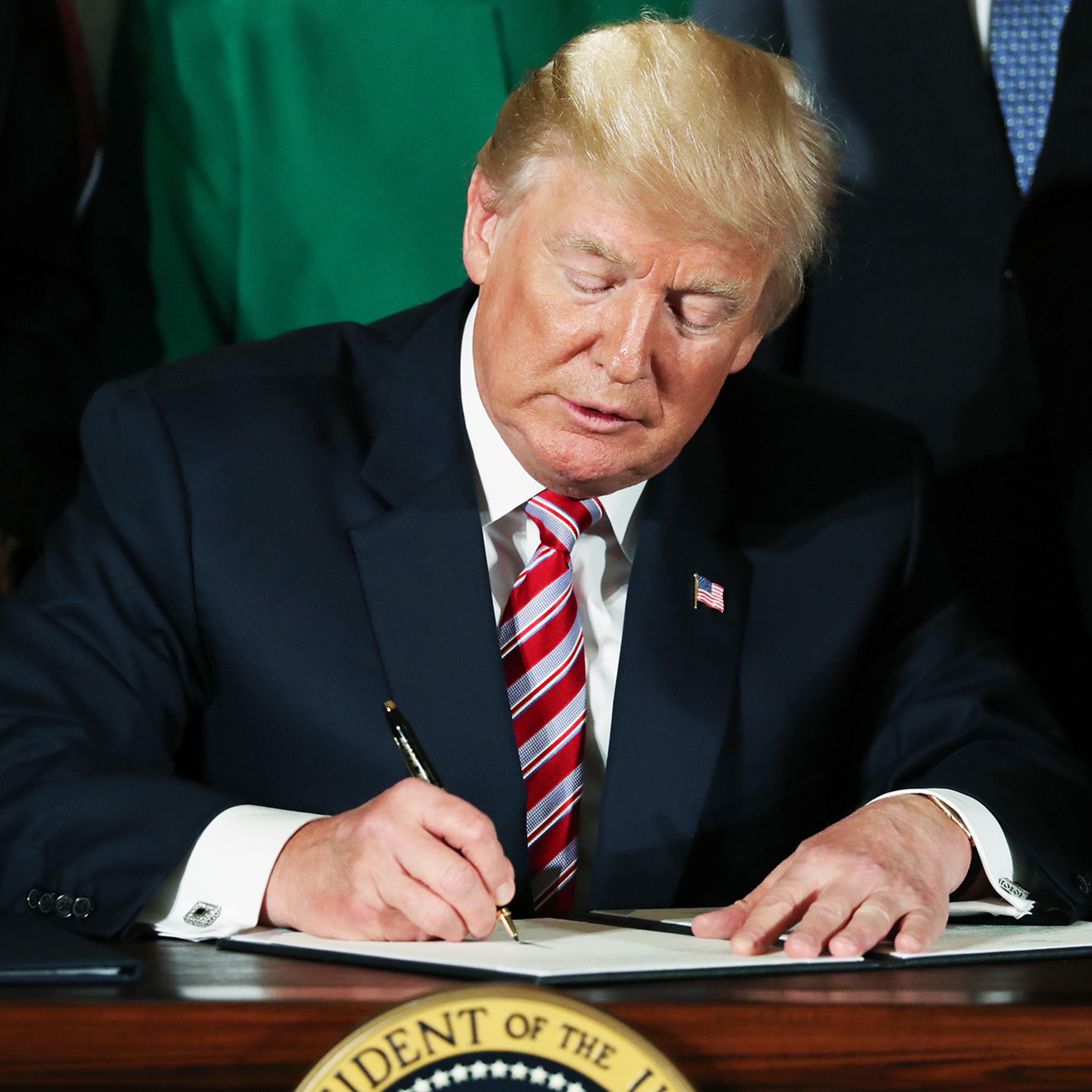 Donald Trump signs a decision memo and a letter to members of Congress outlining the principles of his plan to privatize the nation's air traffic control system in the East Room at the White House, on June 5, 2017, in Washington, D.C.