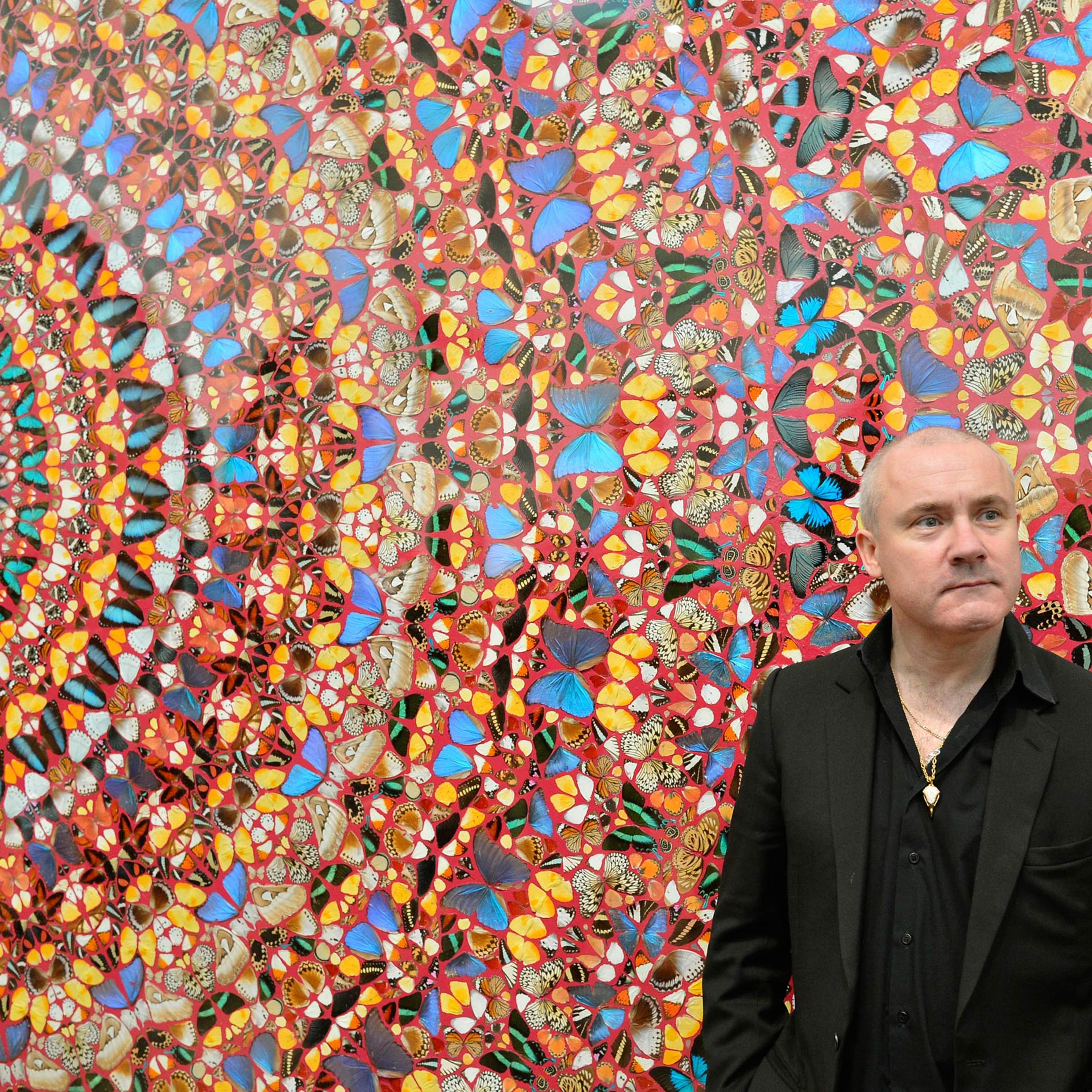British artist Damien Hirst poses next to his painting "I Am Become Death, Shatterer of Worlds", at the Tate Modern gallery in London