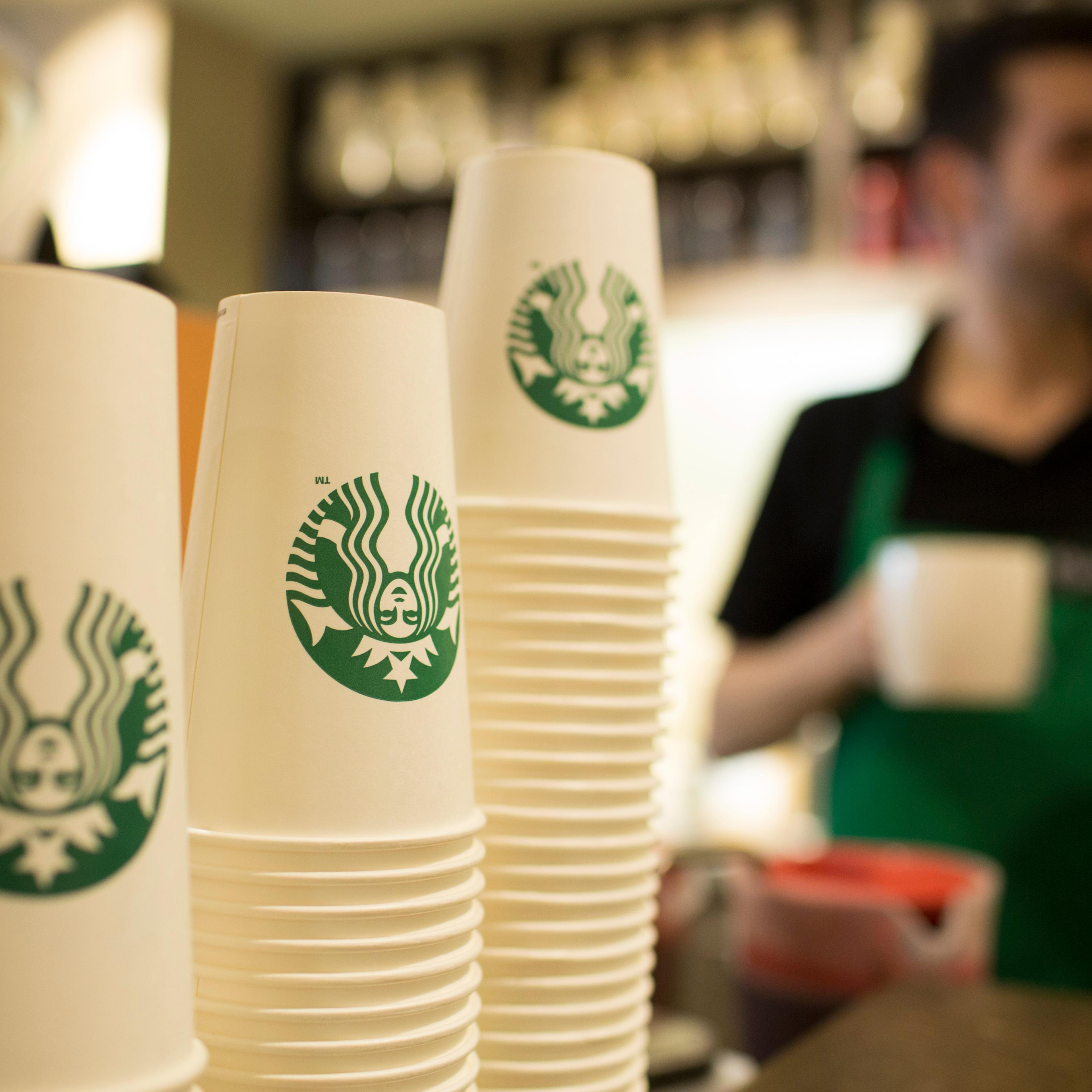 The Starbucks Corp. logo sits on cardboard coffee cups inside a Starbucks Corp. shop in London, U.K., on Monday, June 9, 2014.