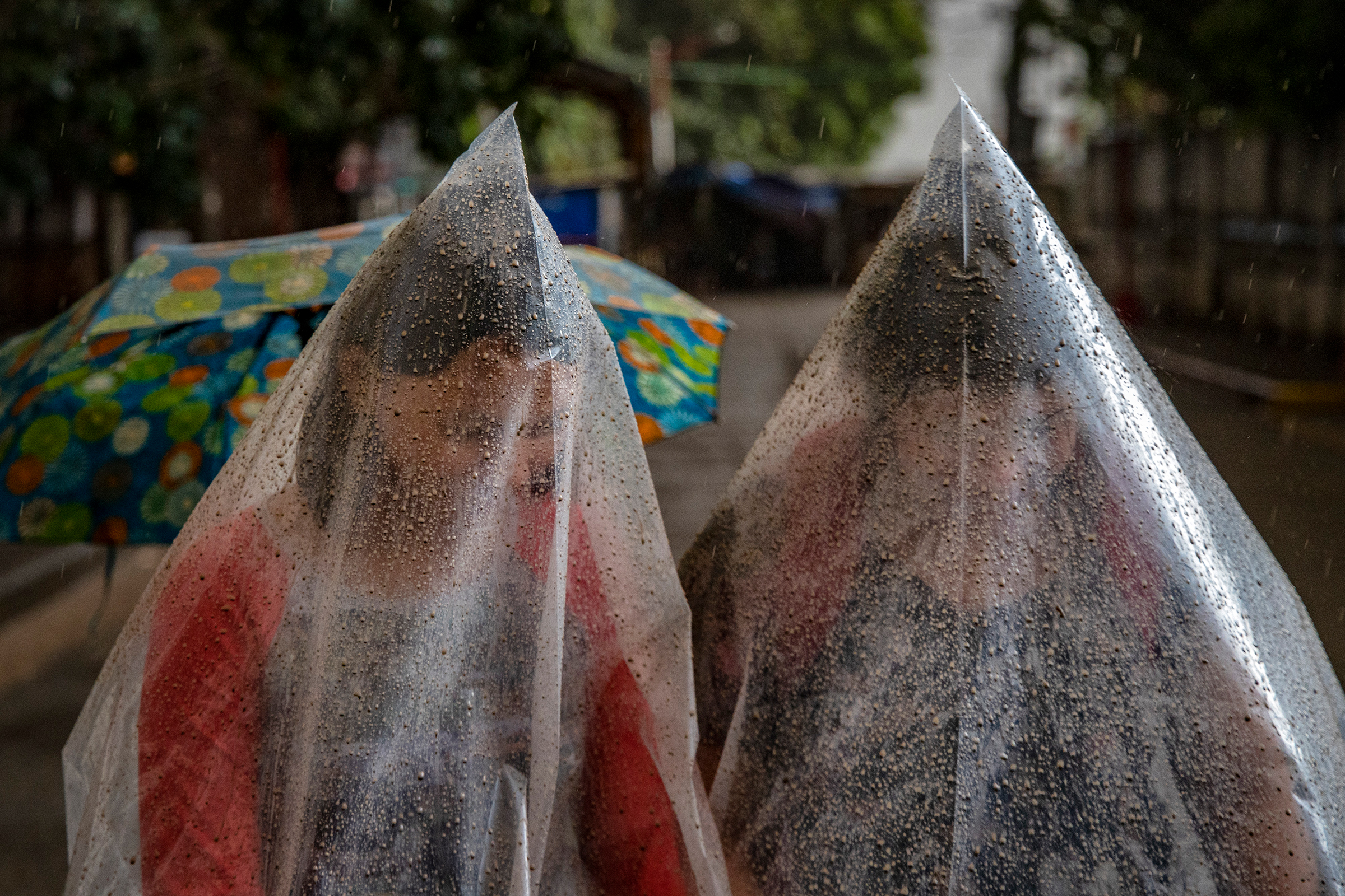 Residents in Talisay use plastic bags to shield themselves from ash and rainwater as the Taal volcano erupts on Jan. 12.
