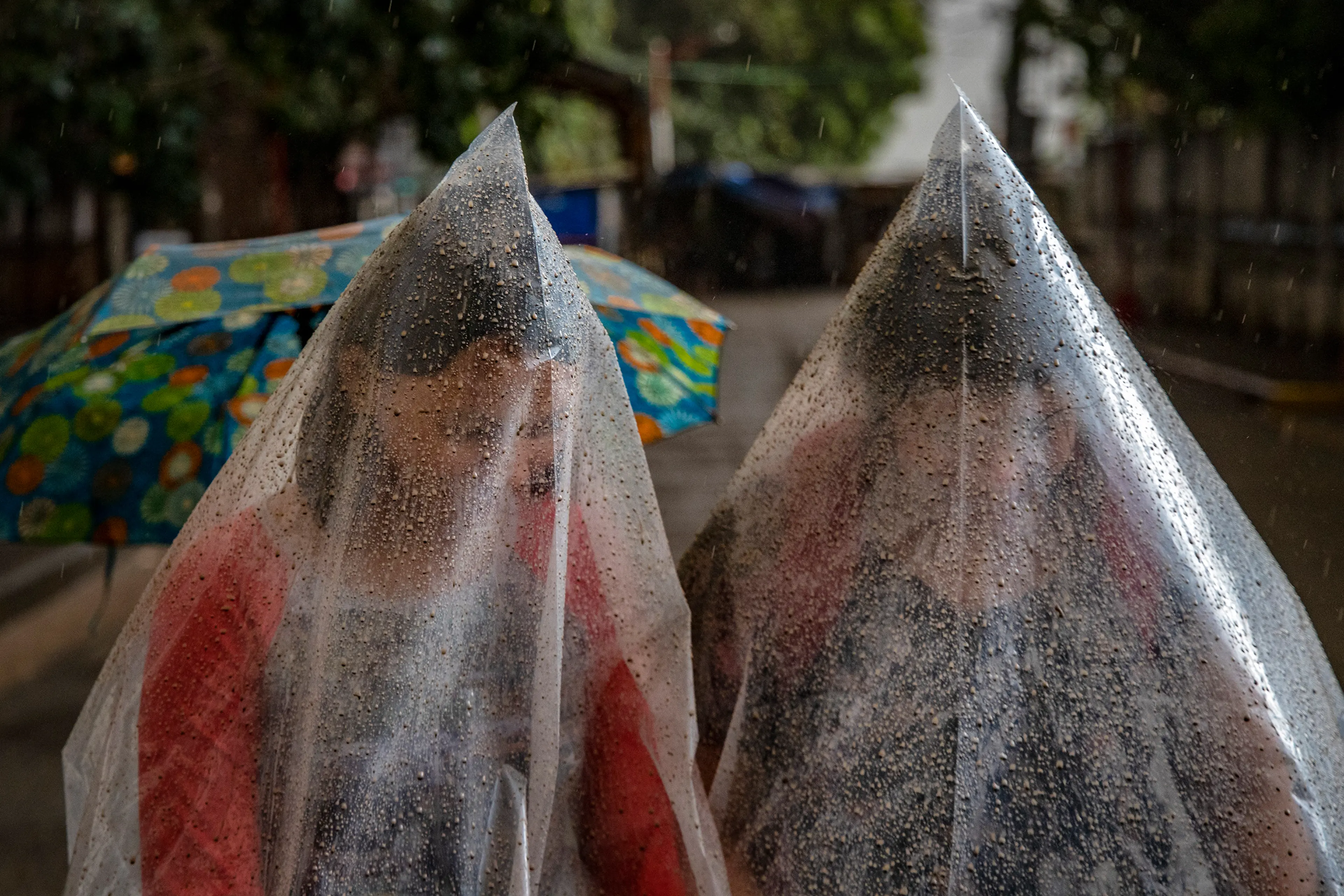 Residents in Talisay use plastic bags to shield themselves from ash and rainwater as the Taal volcano erupts on Jan. 12.