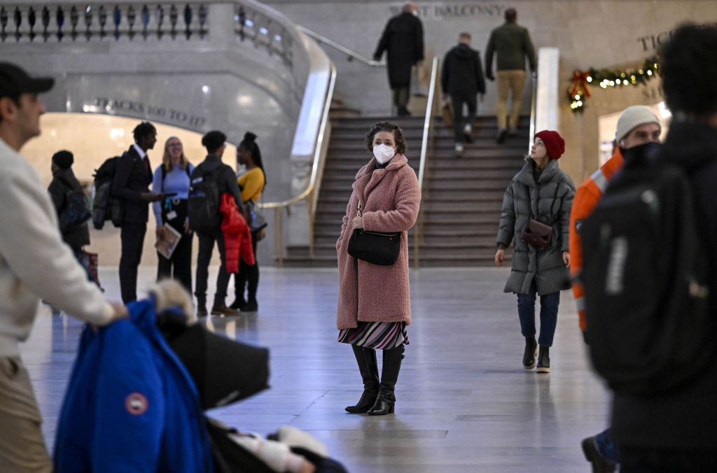 A woman wears a mask in the midst of a new COVID-19 surge