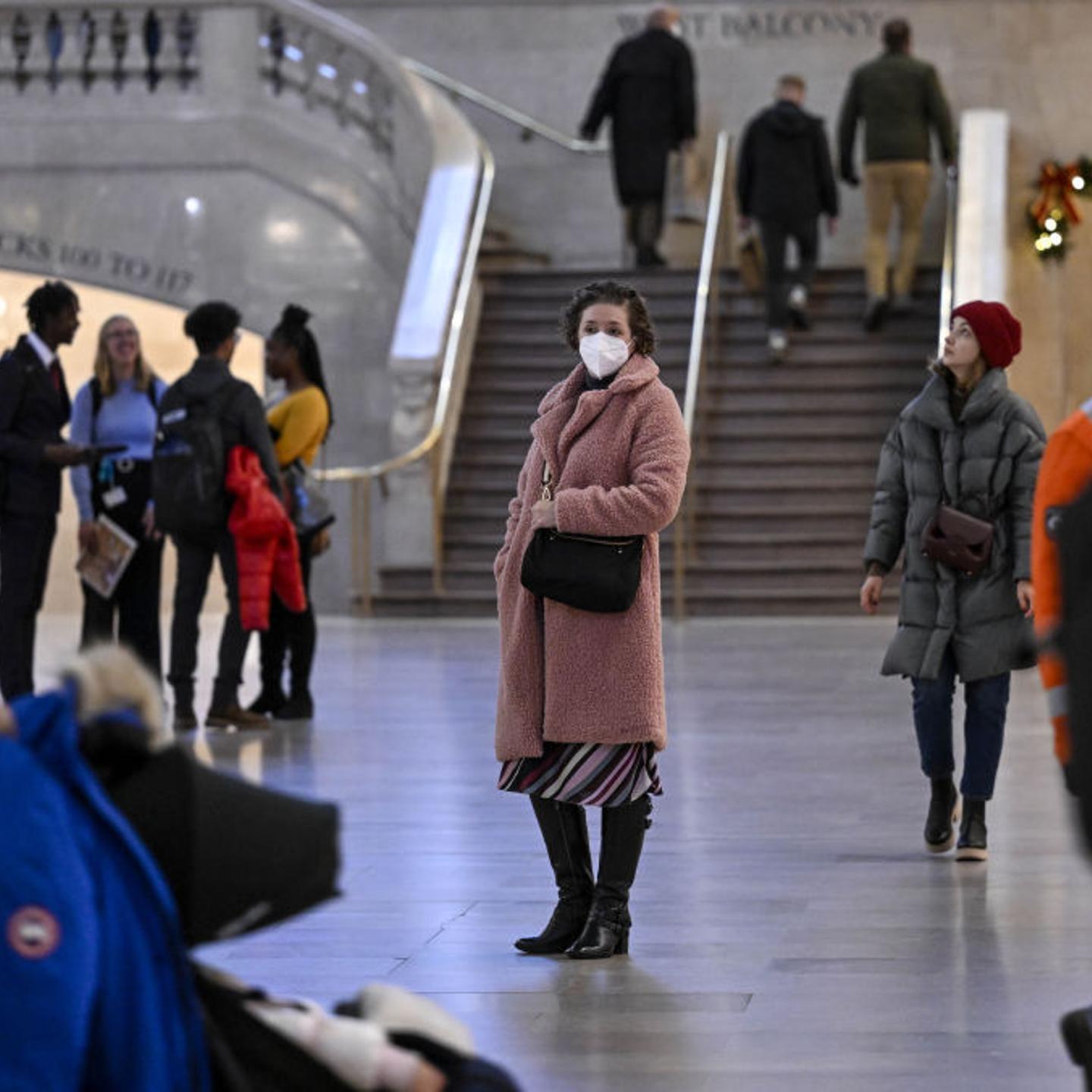 A woman wears a mask in the midst of a new COVID-19 surge