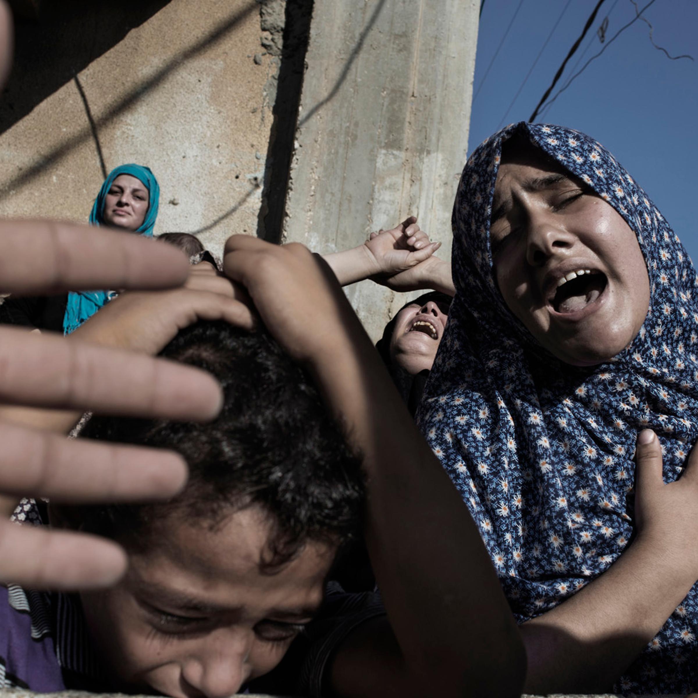 Gaza Strip, Gaza City: Relatives of four boys, all from the Bakr family, killed by Israeli naval bombardment, mourn during their funeral in Gaza City, on July 16, 2014. . ALESSIO ROMENZI
