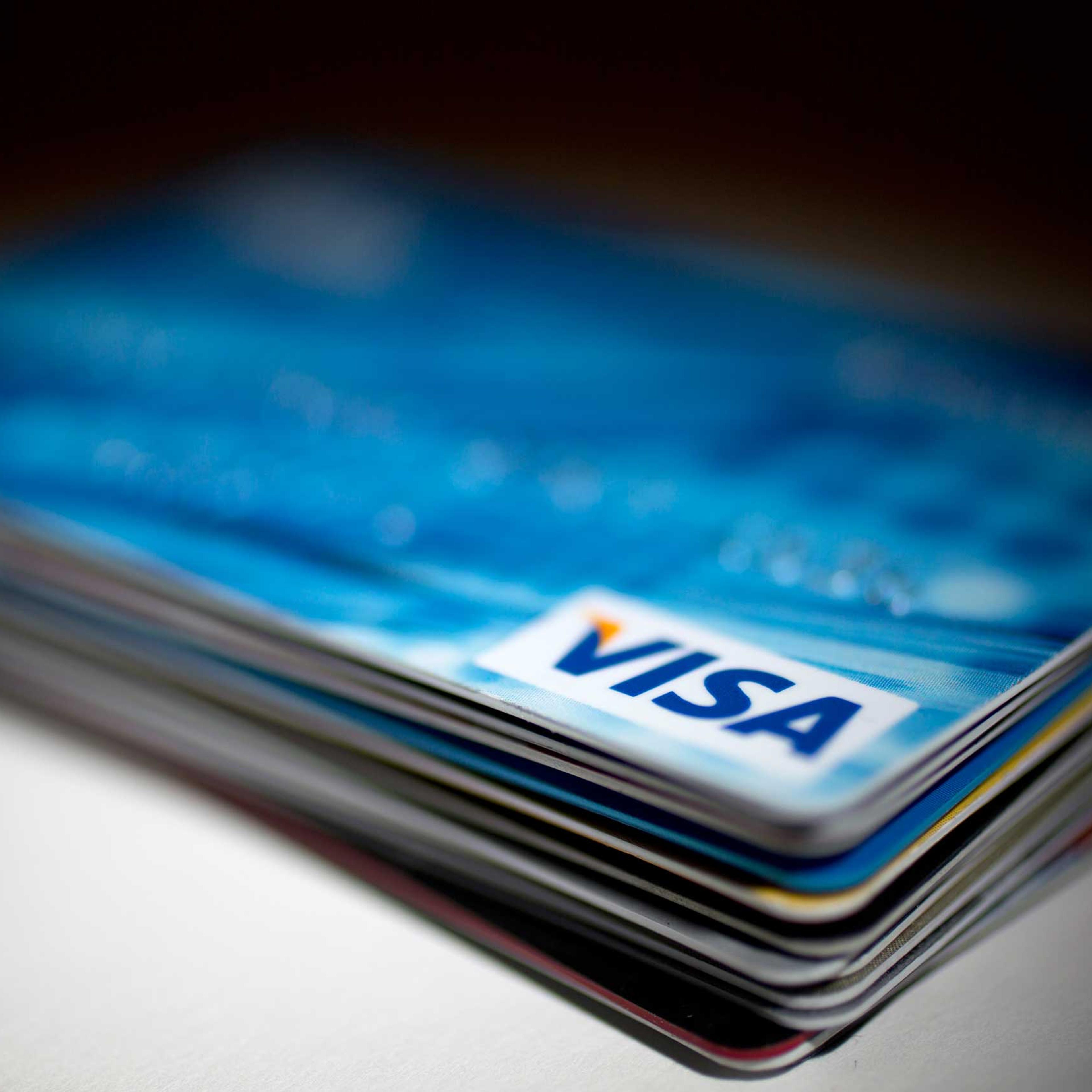 A Visa Inc. credit card sits on top of credit and debit cards arranged for a photograph in Washington on Jan. 29, 2014.