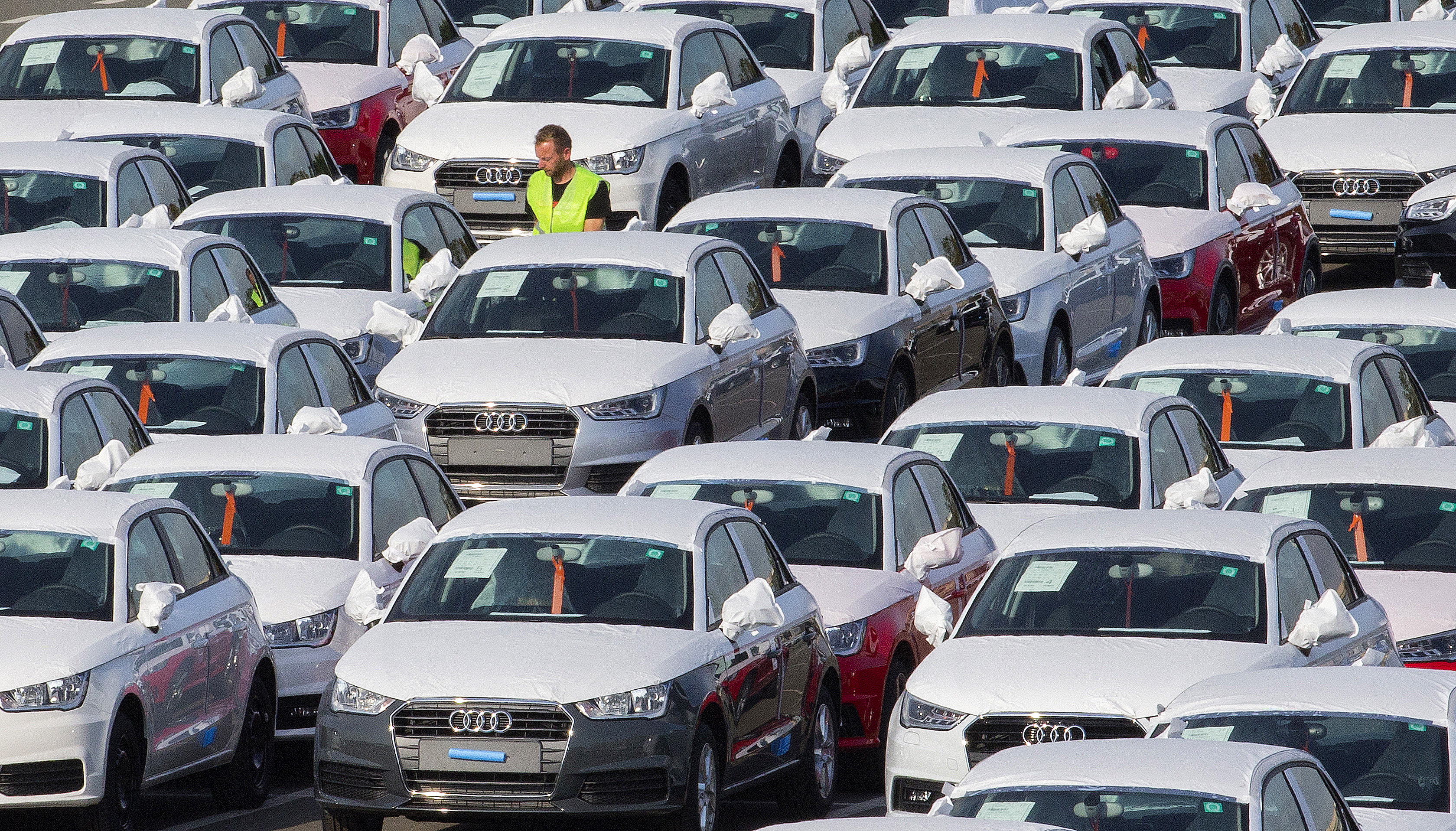 A worker walks among Audi A1 cars in the parking of the Audi powerplant in Brussels