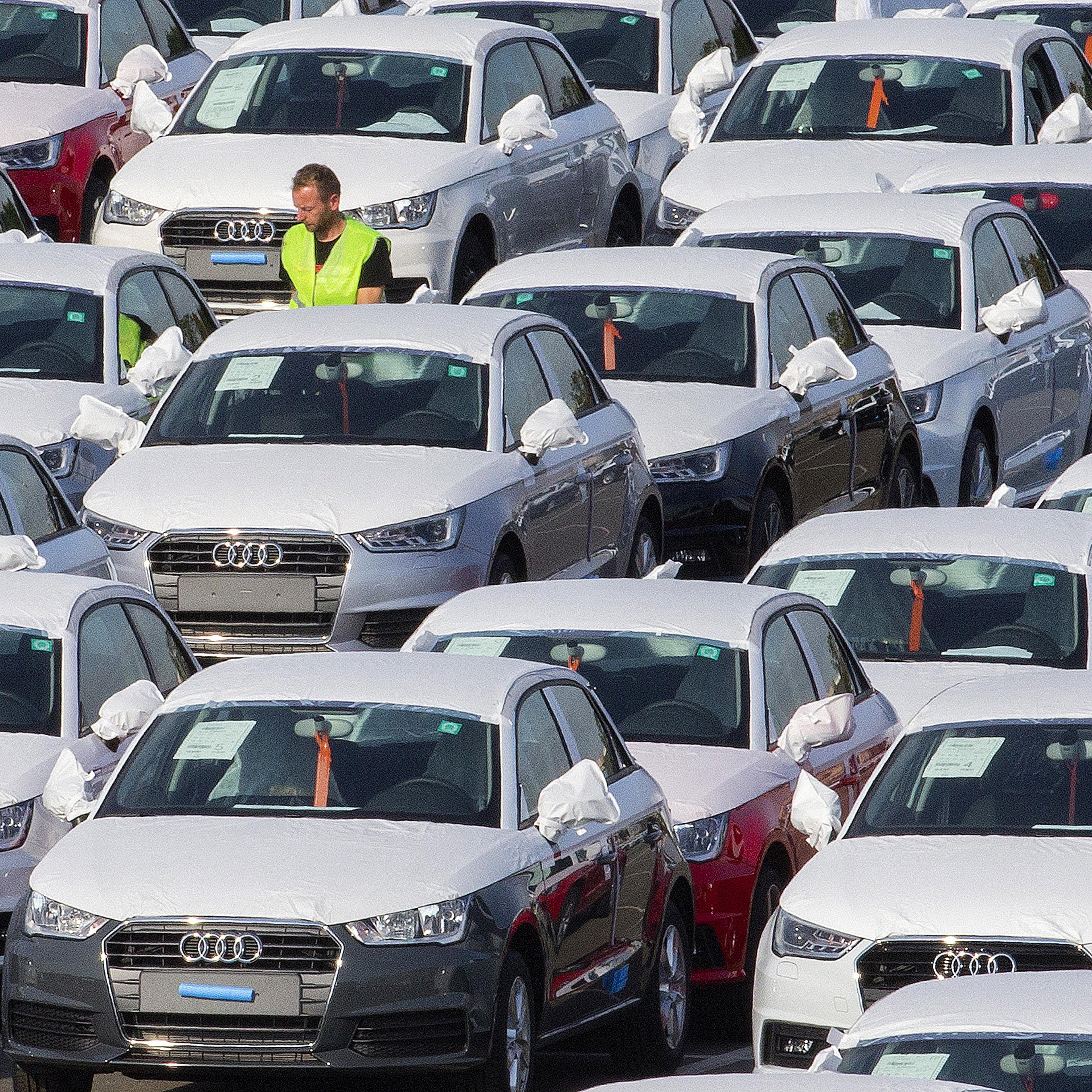 A worker walks among Audi A1 cars in the parking of the Audi powerplant in Brussels