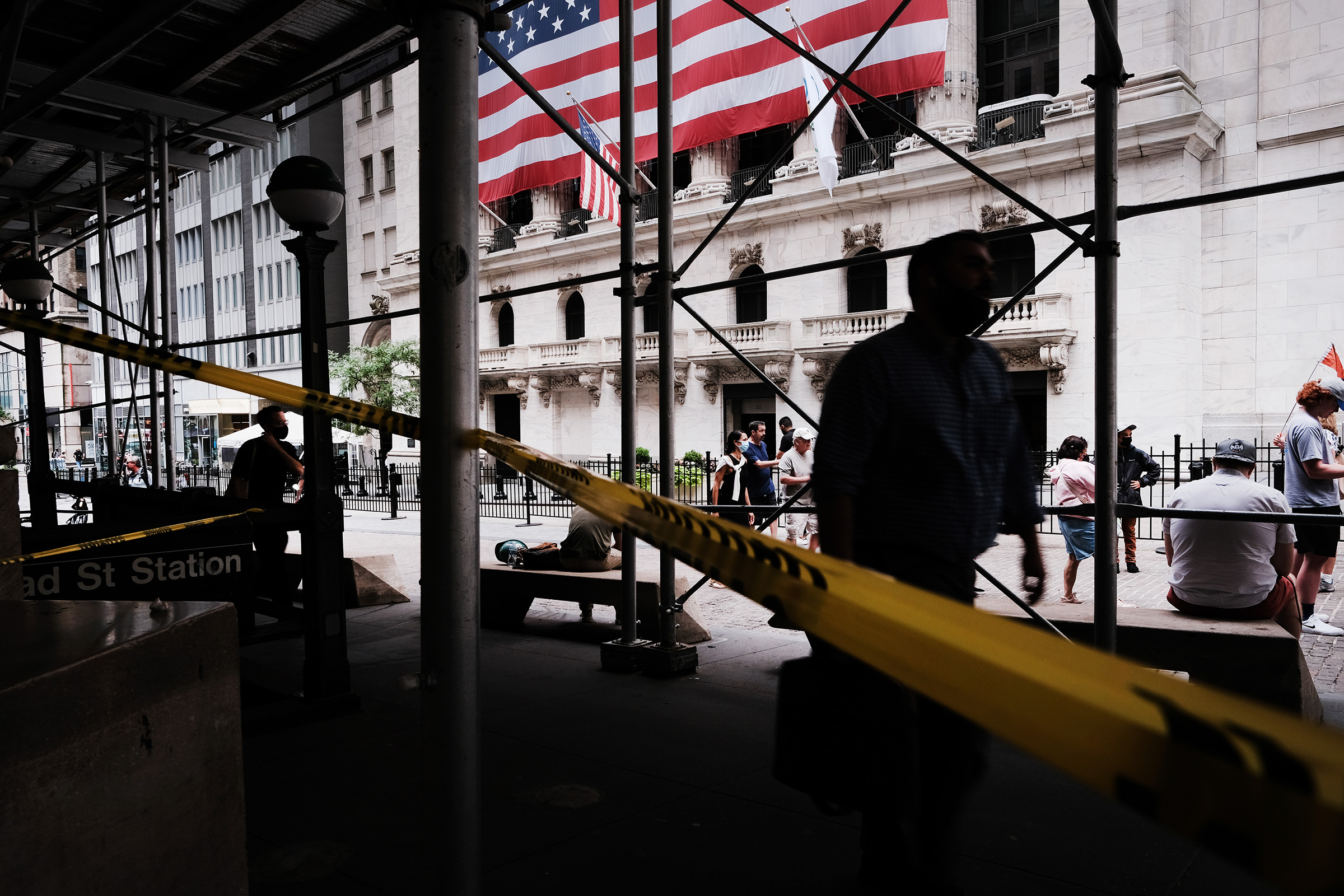 People walk by the New York Stock Exchange in New York City on Aug. 10, 2021