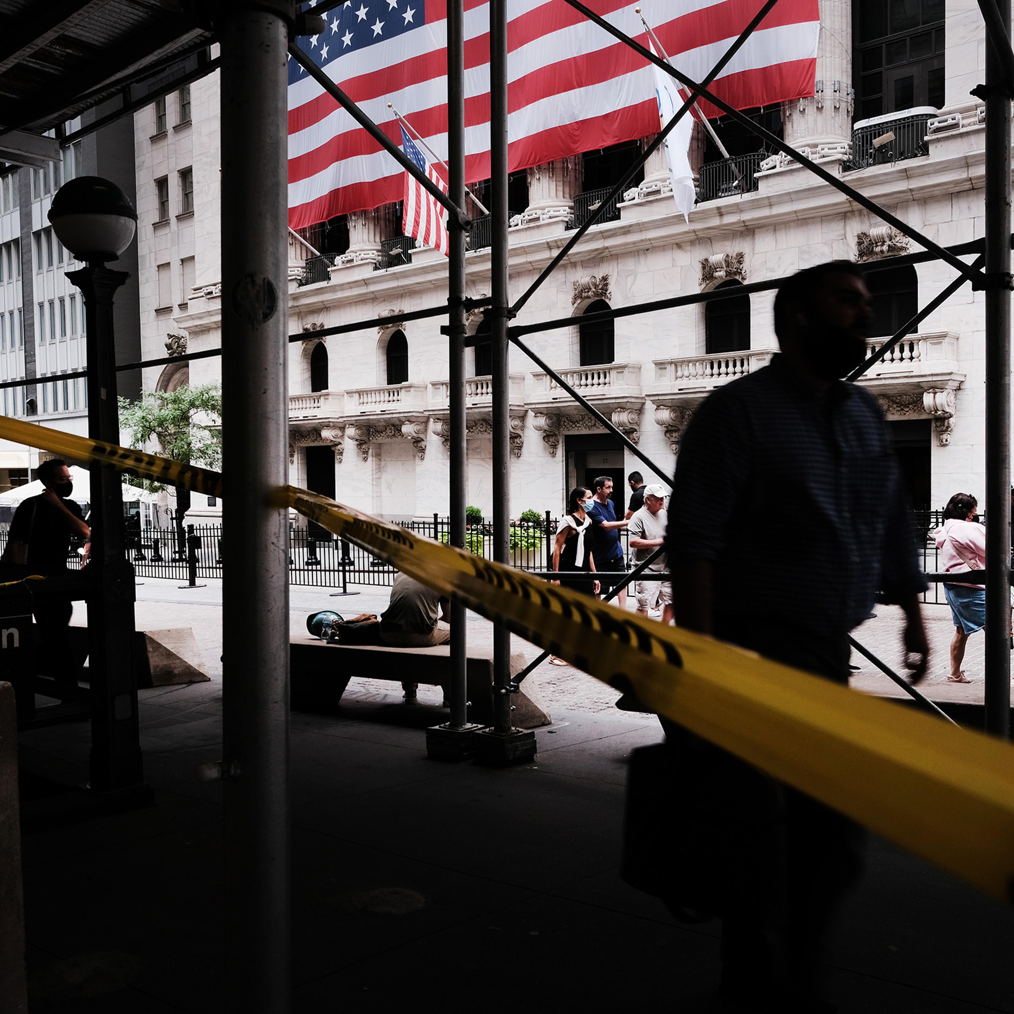 People walk by the New York Stock Exchange in New York City on Aug. 10, 2021