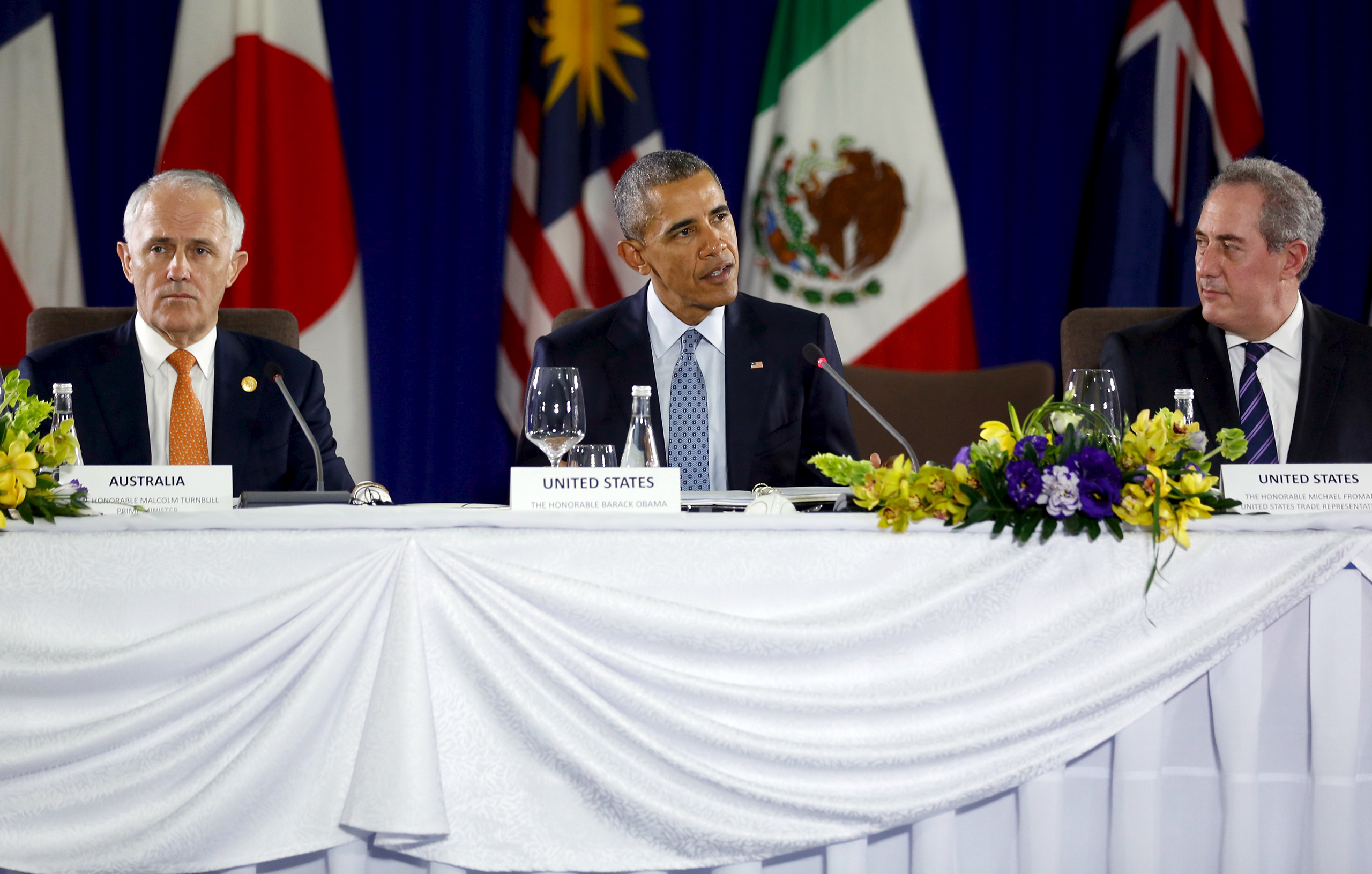 U.S. President Barack Obama (C), flanked by Australia Prime Minister Malcolm Turnbull (L) and U.S. Trade Representative Michael Froman (R), delivers remarks at a meeting with Trans-Pacific Partnership leaders, alongside the APEC Summit in Manila, Philipp