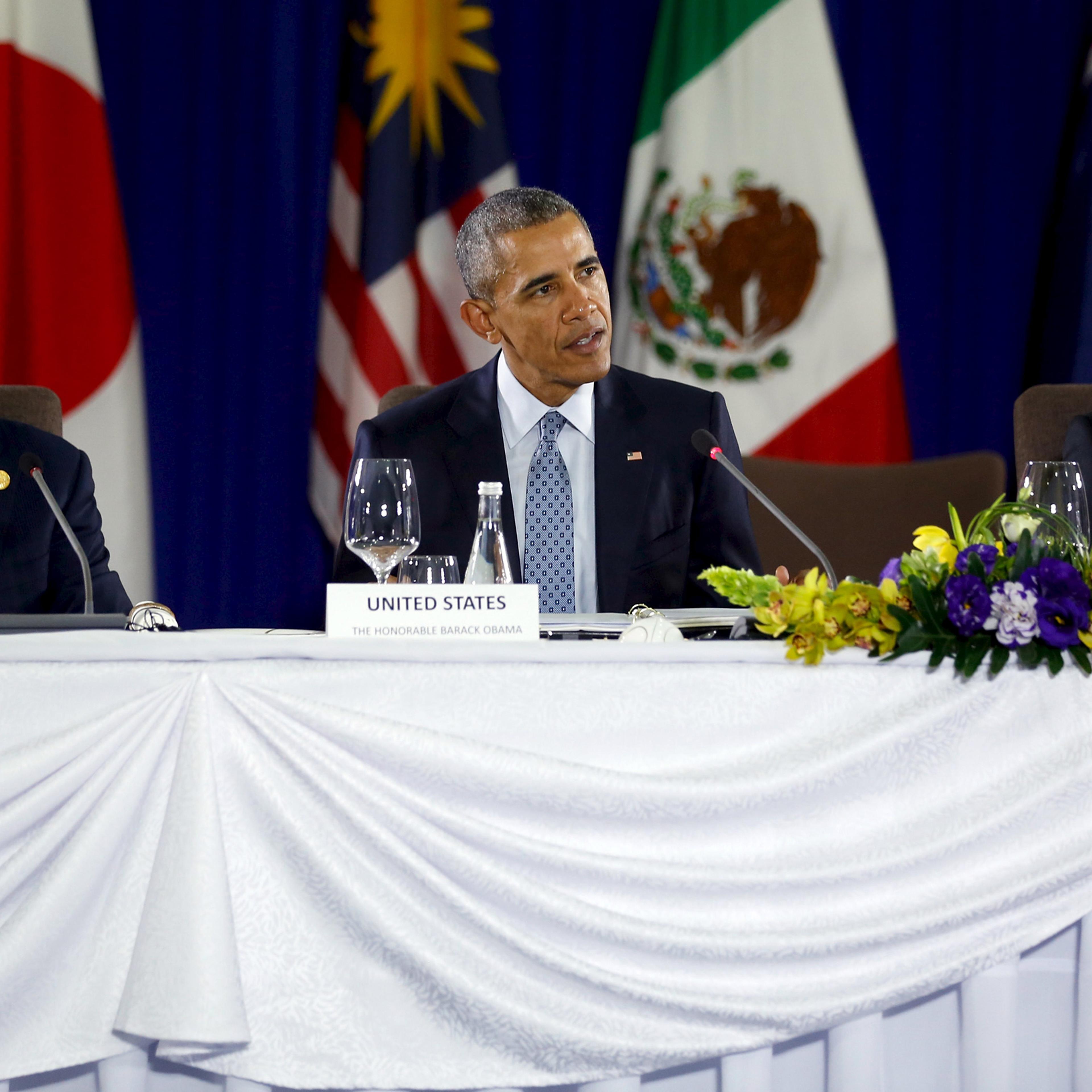 U.S. President Barack Obama (C), flanked by Australia Prime Minister Malcolm Turnbull (L) and U.S. Trade Representative Michael Froman (R), delivers remarks at a meeting with Trans-Pacific Partnership leaders, alongside the APEC Summit in Manila, Philipp