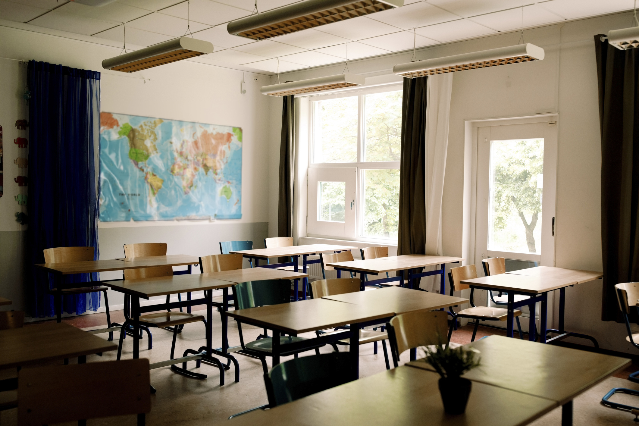 Empty desks and chairs arranged in classroom at high school