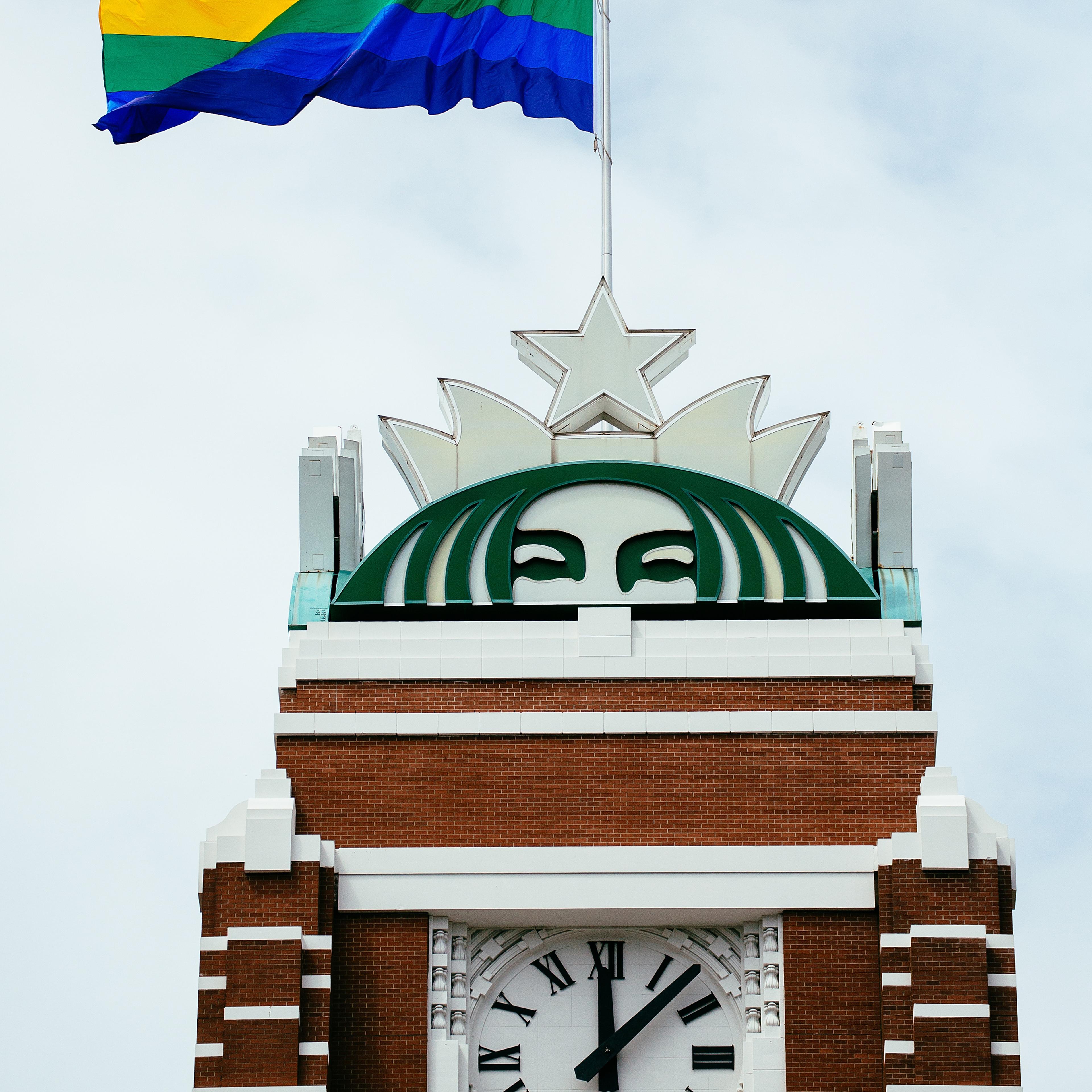 Starbucks marked the 40th anniversary of Seattle Pride by raising an 800-square-foot flag at its corporate headquarters as a group of employees and CEO Howard Schultz watched from below in Seattle on June 20, 2014.