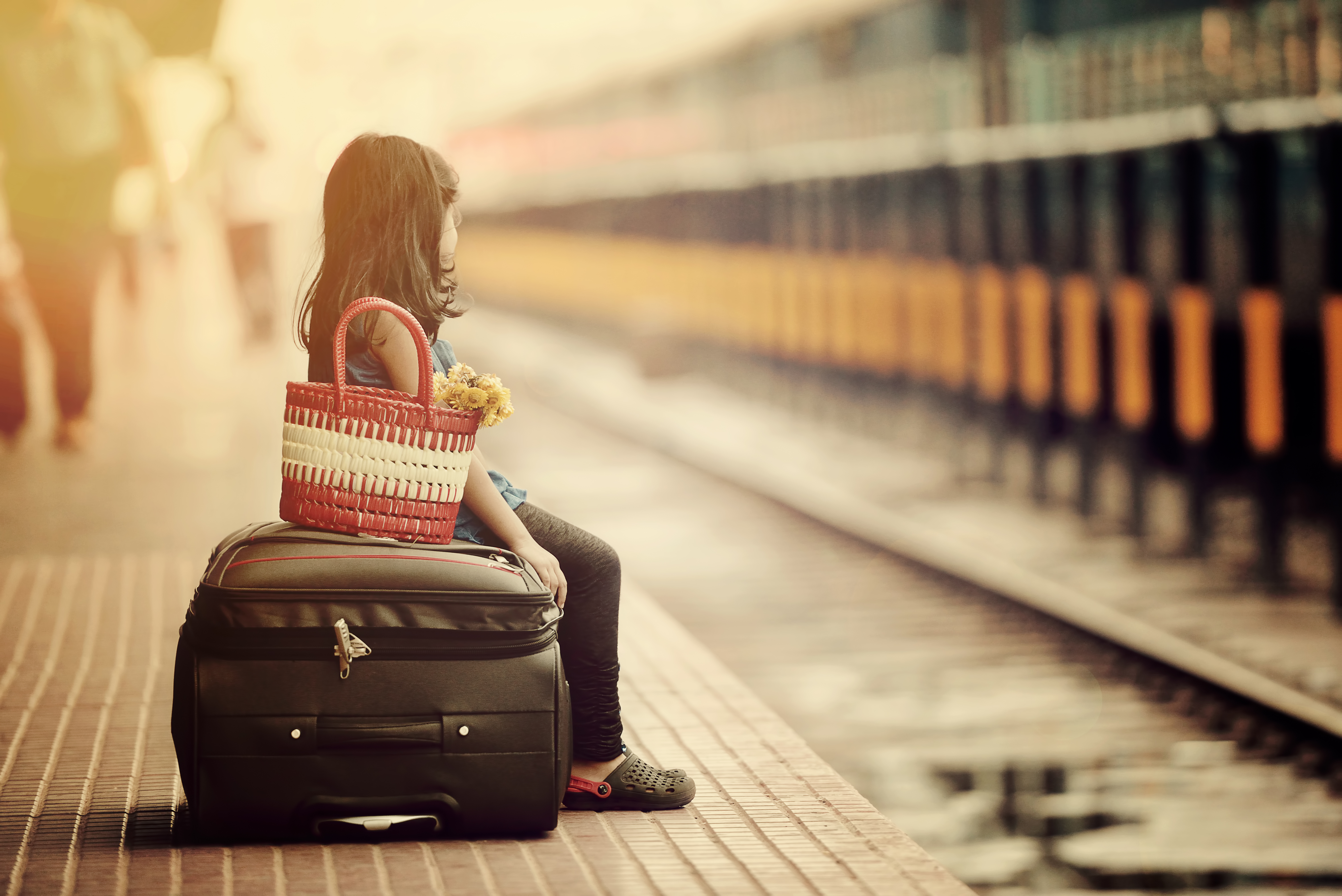 Little girl waiting in a railway station