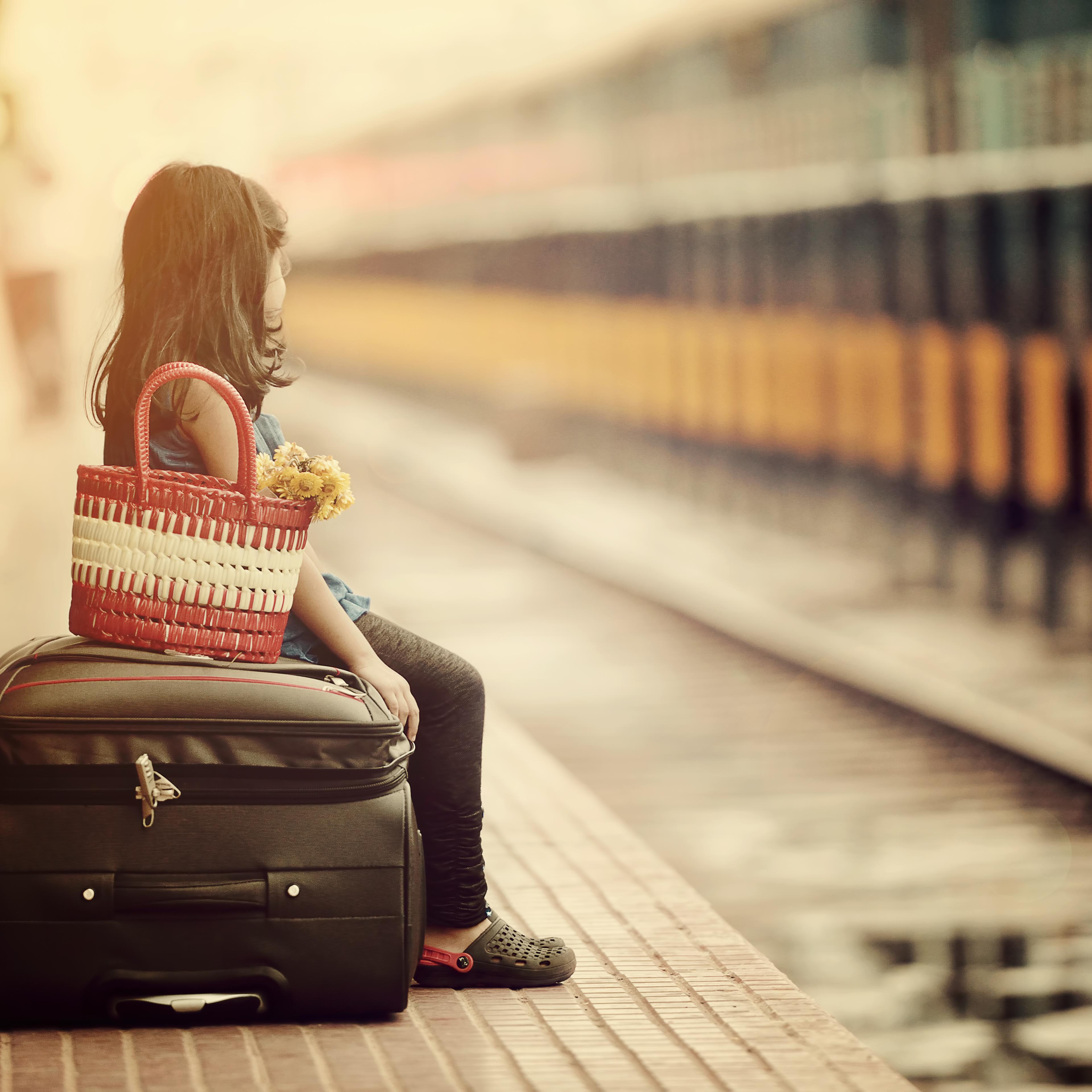 Little girl waiting in a railway station