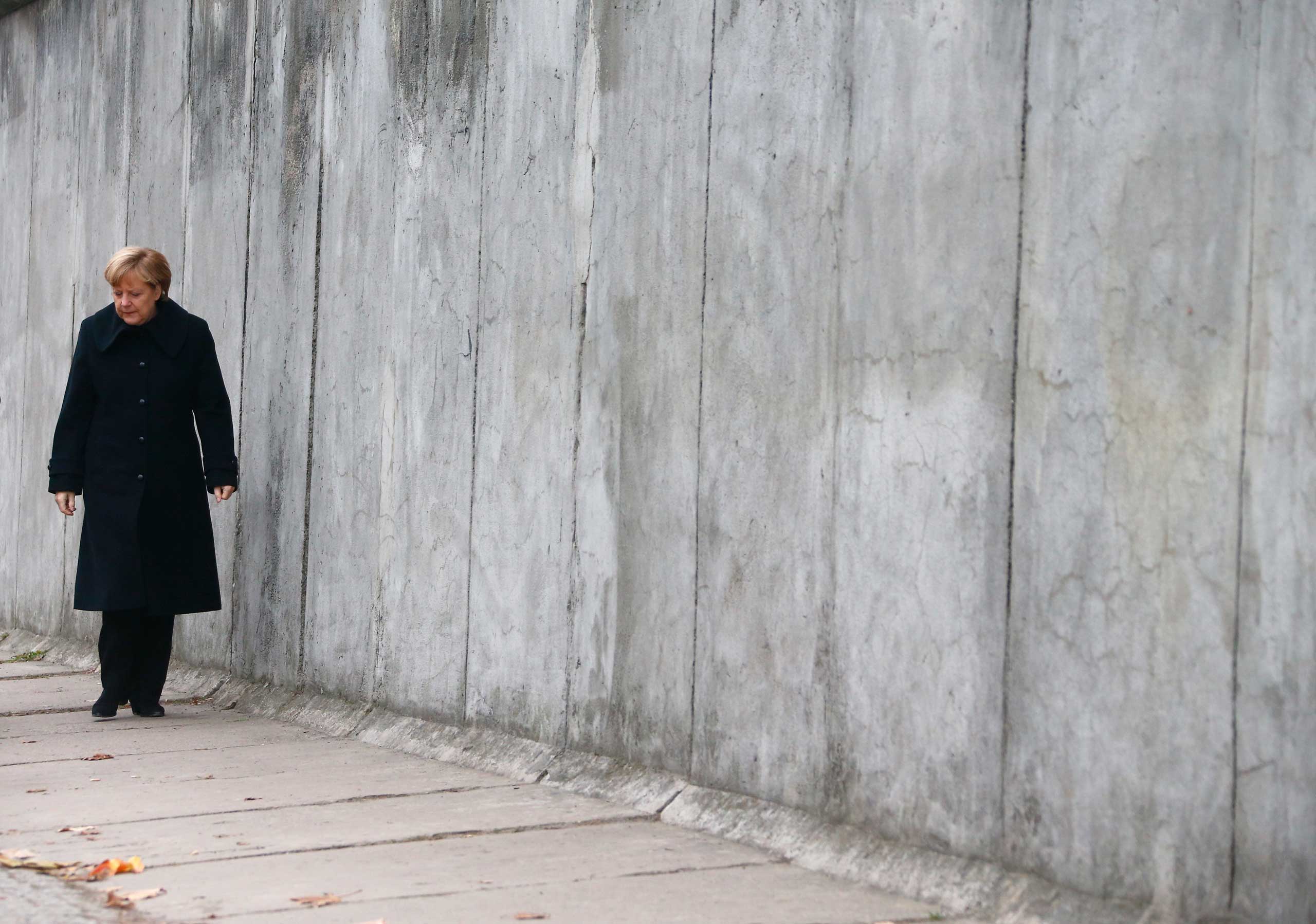 German Chancellor Merkel walks along former Berlin Wall during ceremony marking 25th anniversary of fall of the Wall in Berlin