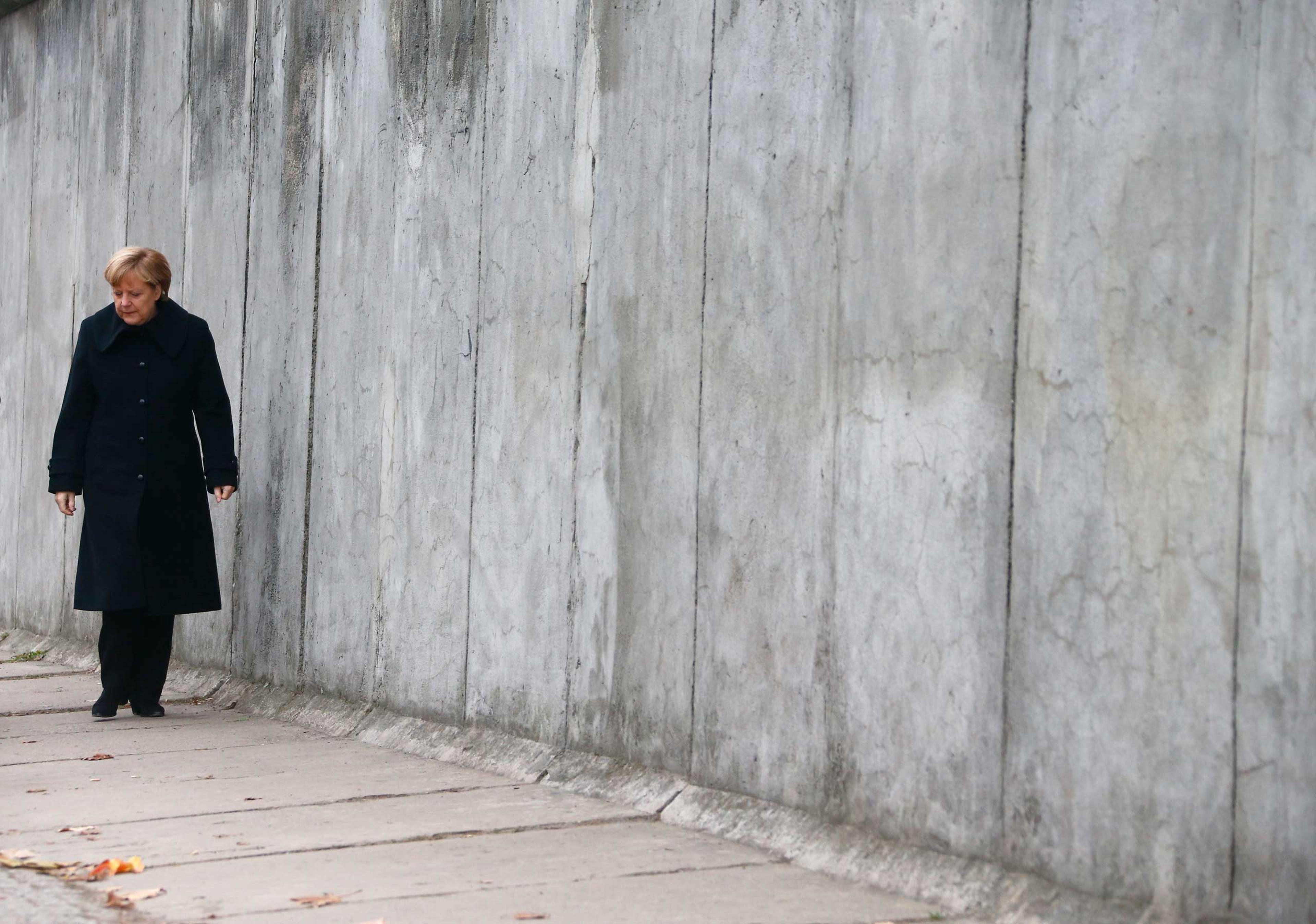 German Chancellor Merkel walks along former Berlin Wall during ceremony marking 25th anniversary of fall of the Wall in Berlin