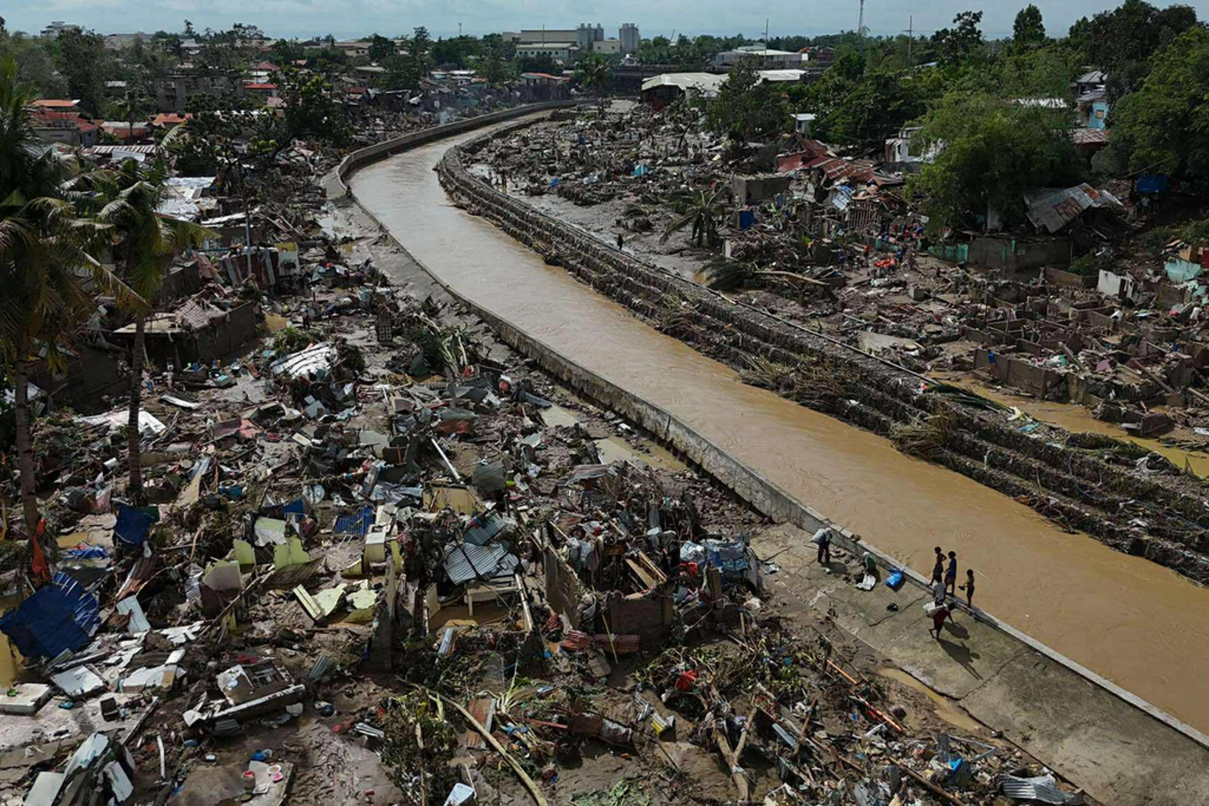 Residents return to what remains of their homes after Typhoon Kalmaegi devastated communities along the Mananga River in Talisay City, Cebu province, central Philippines, on Nov. 5, 2025.