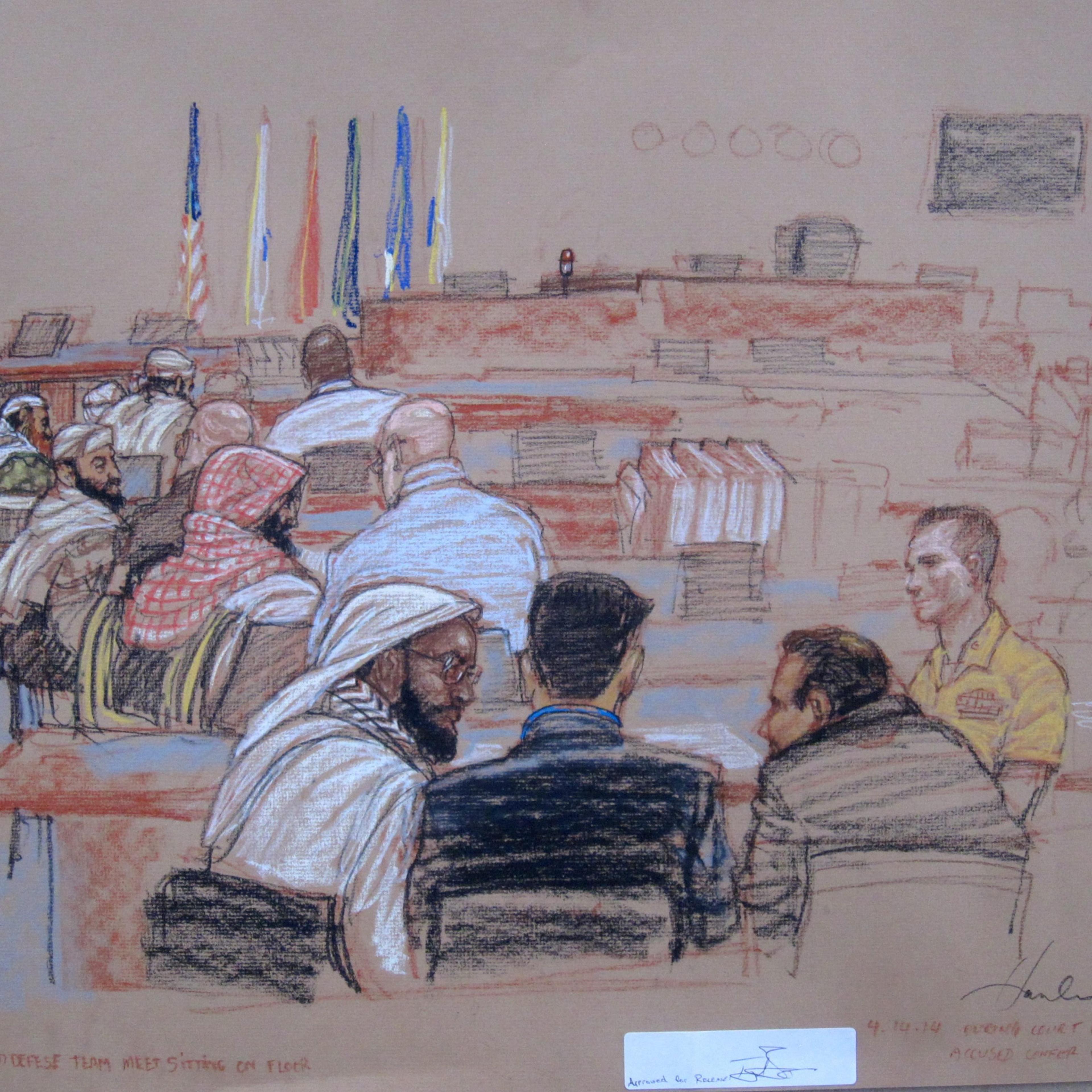 The 9/11 accused confer with their defense lawyers during a break in pretrial hearings at the U.S. Navy base Guantanamo Bay, Cuba, on April 14, 2014.