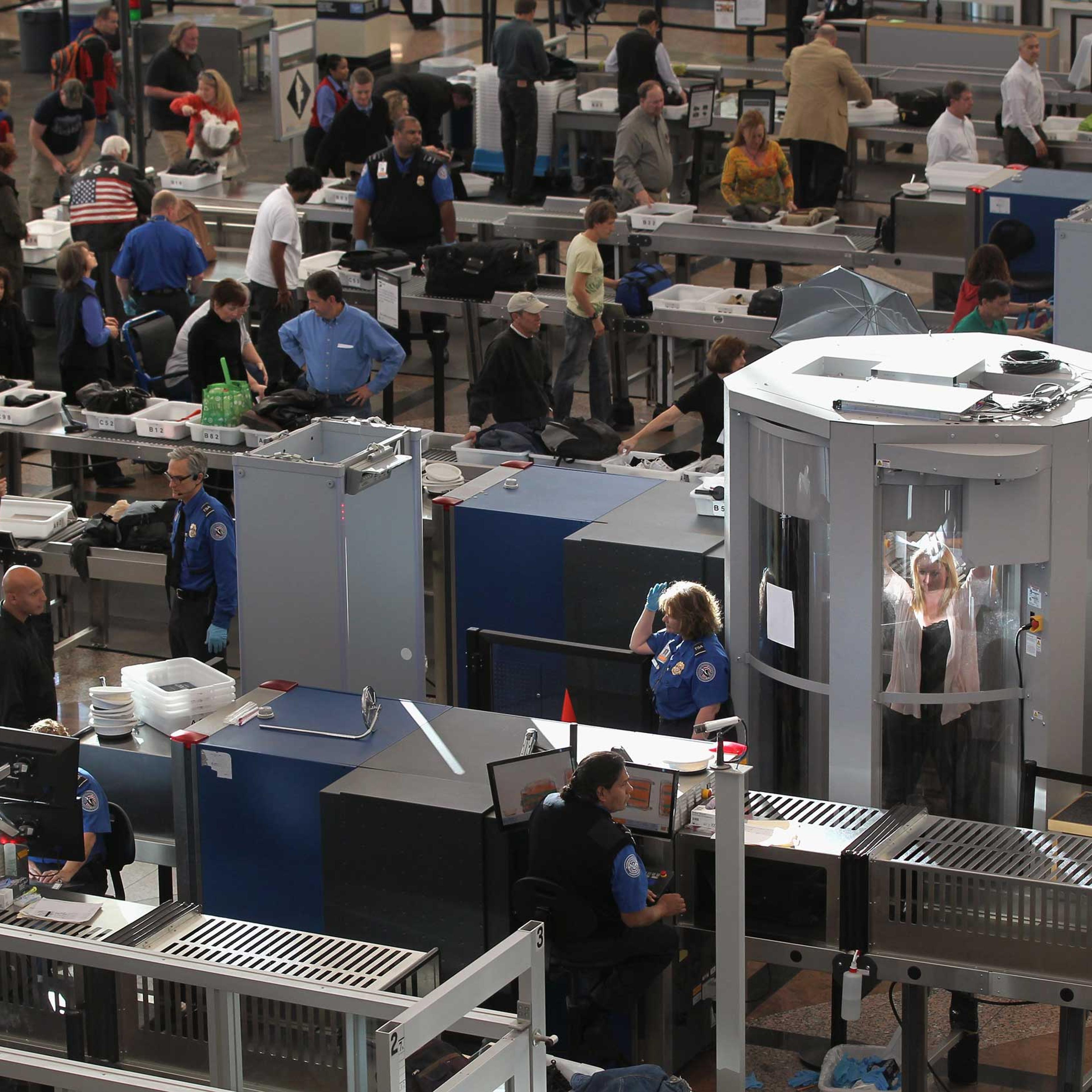 Transportation Security Administration agents screen passengers at Denver International Airport in 2010.
