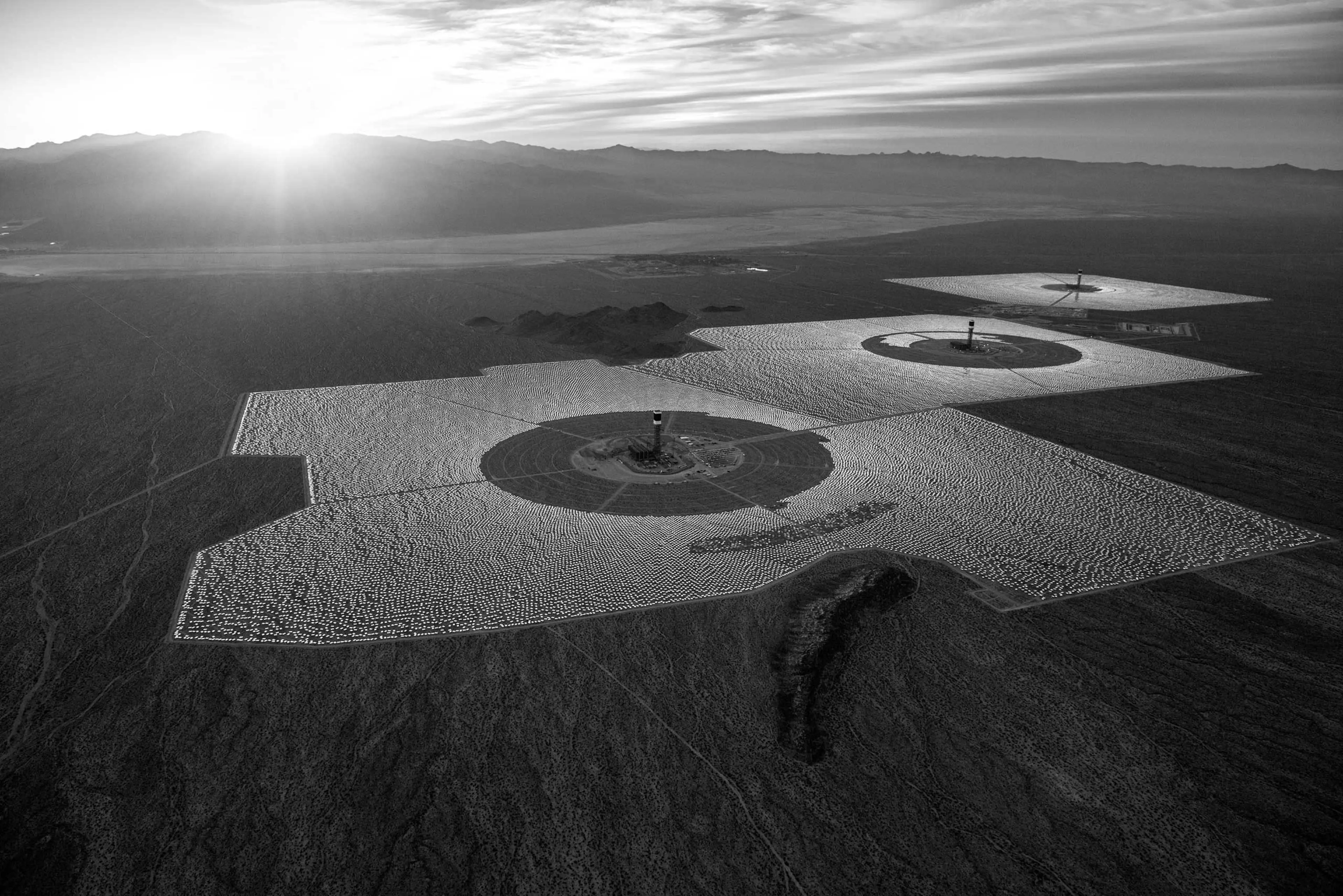 in the Mojave Desert, California. Unlike solar photovoltaic plants, which generate electricity directly from sunlight, Ivanpah uses hundreds of thousands of curved mirrors to reflect and concentrate the desert sunshine. Jamey Stillings