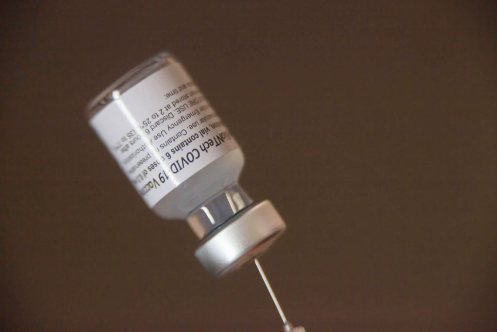 A vaccine vial loaded into a syringe at the mobile clinic on