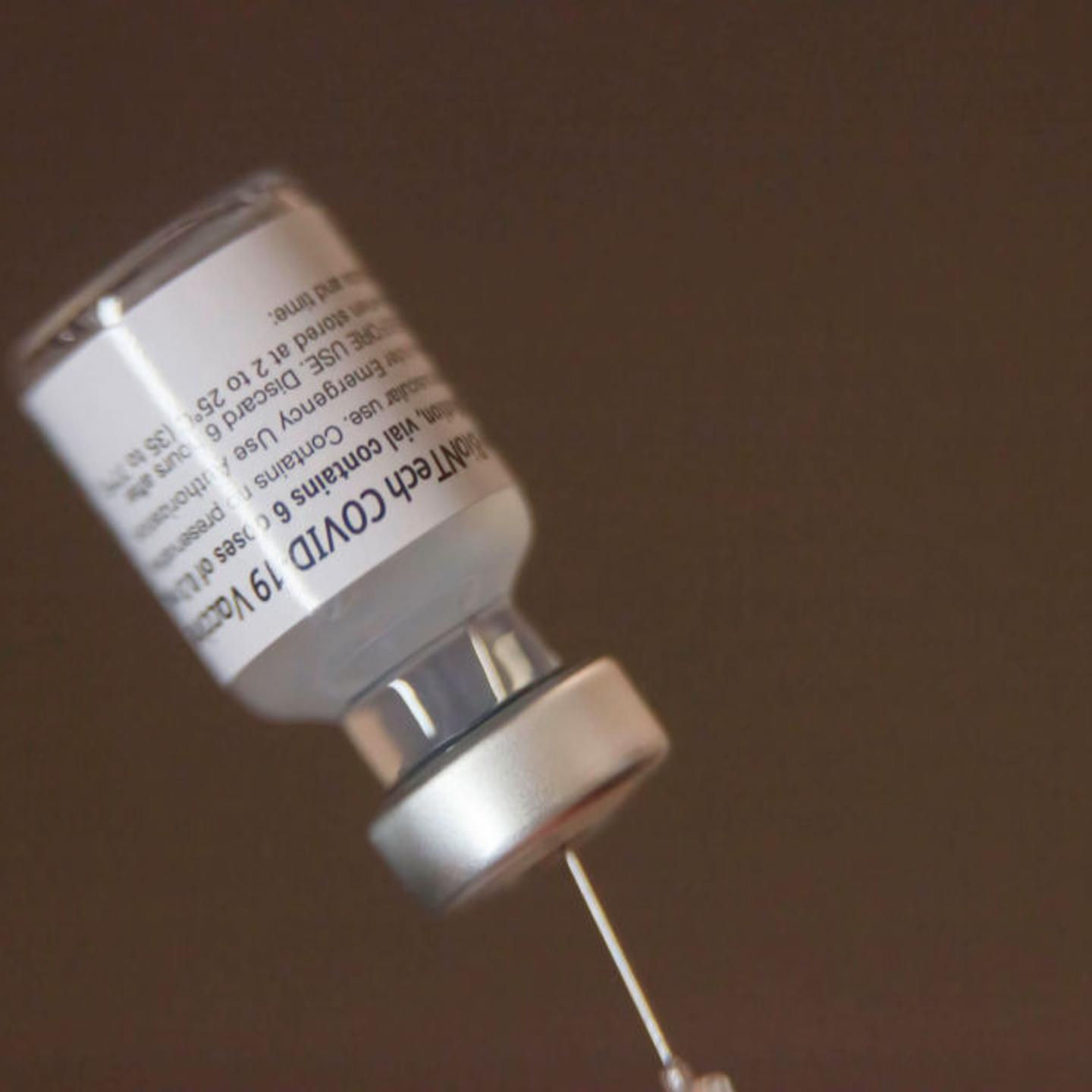A vaccine vial loaded into a syringe at the mobile clinic on