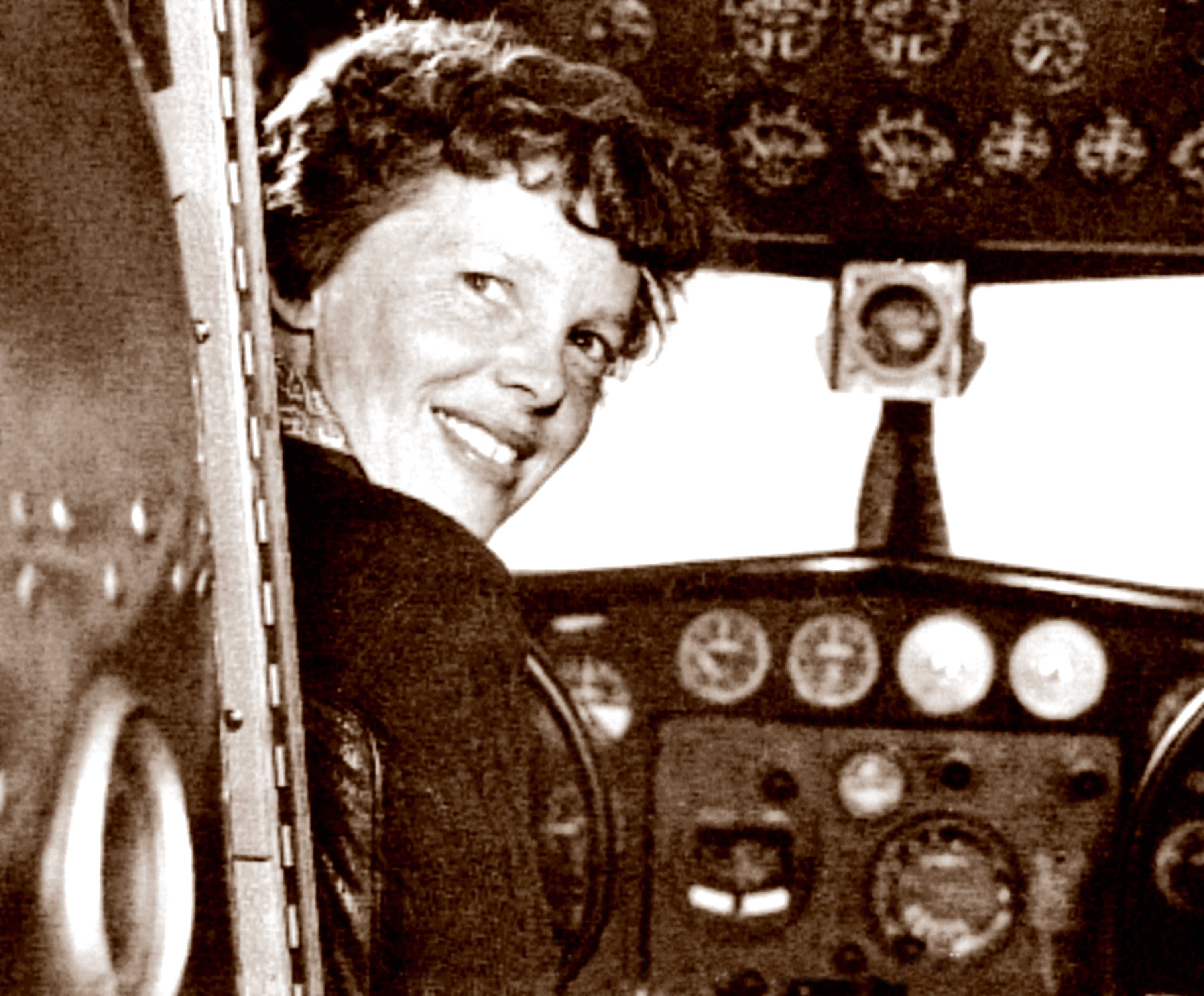 In this May 20, 1937 photo, provided by The Paragon Agency, shows aviator Amelia Earhart at her Electra plane cabin, taken by Albert Bresnik at Burbank Airport in Burbank, Calif.