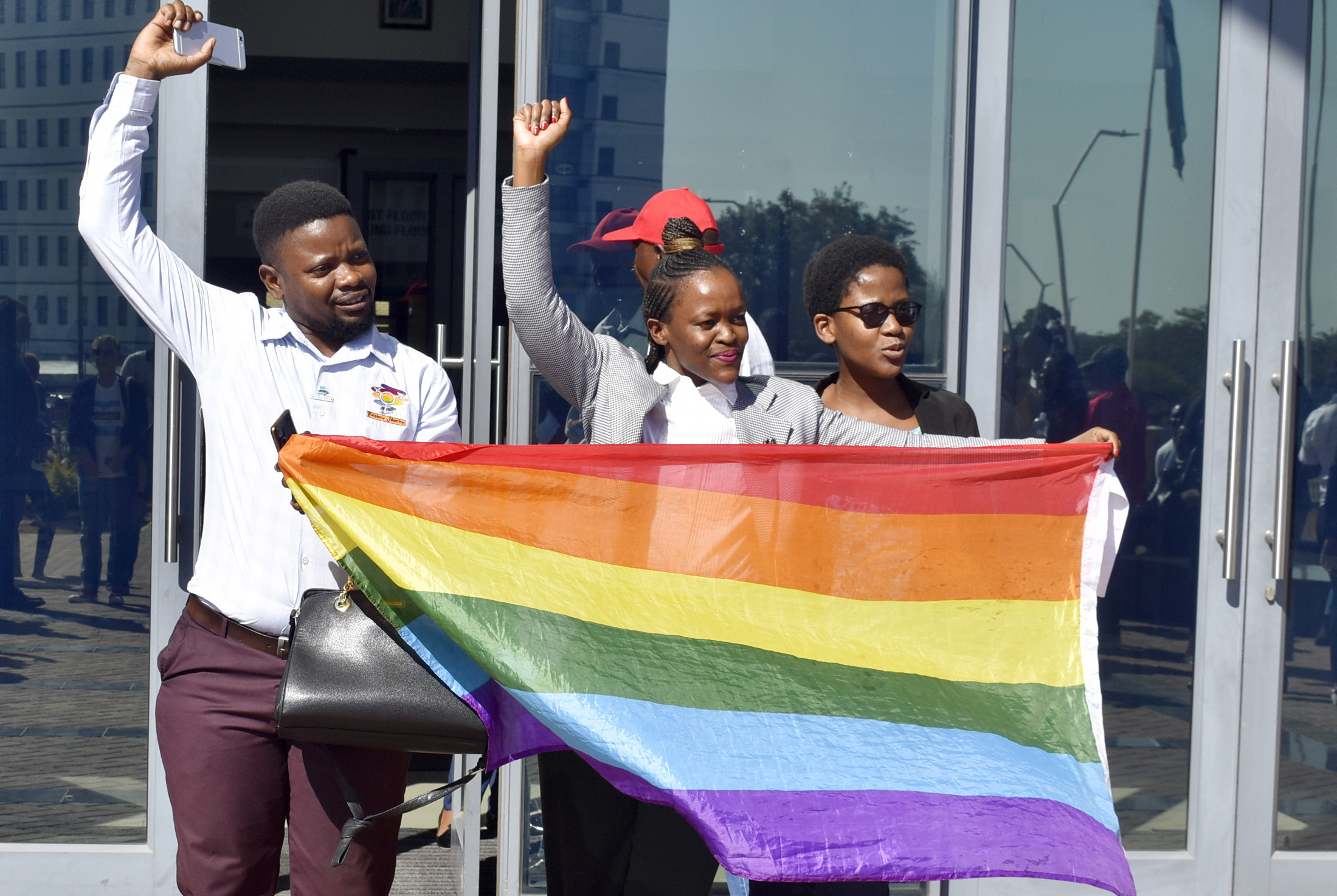 Activists celebrate outside the High Court in Gaborone, Botswana