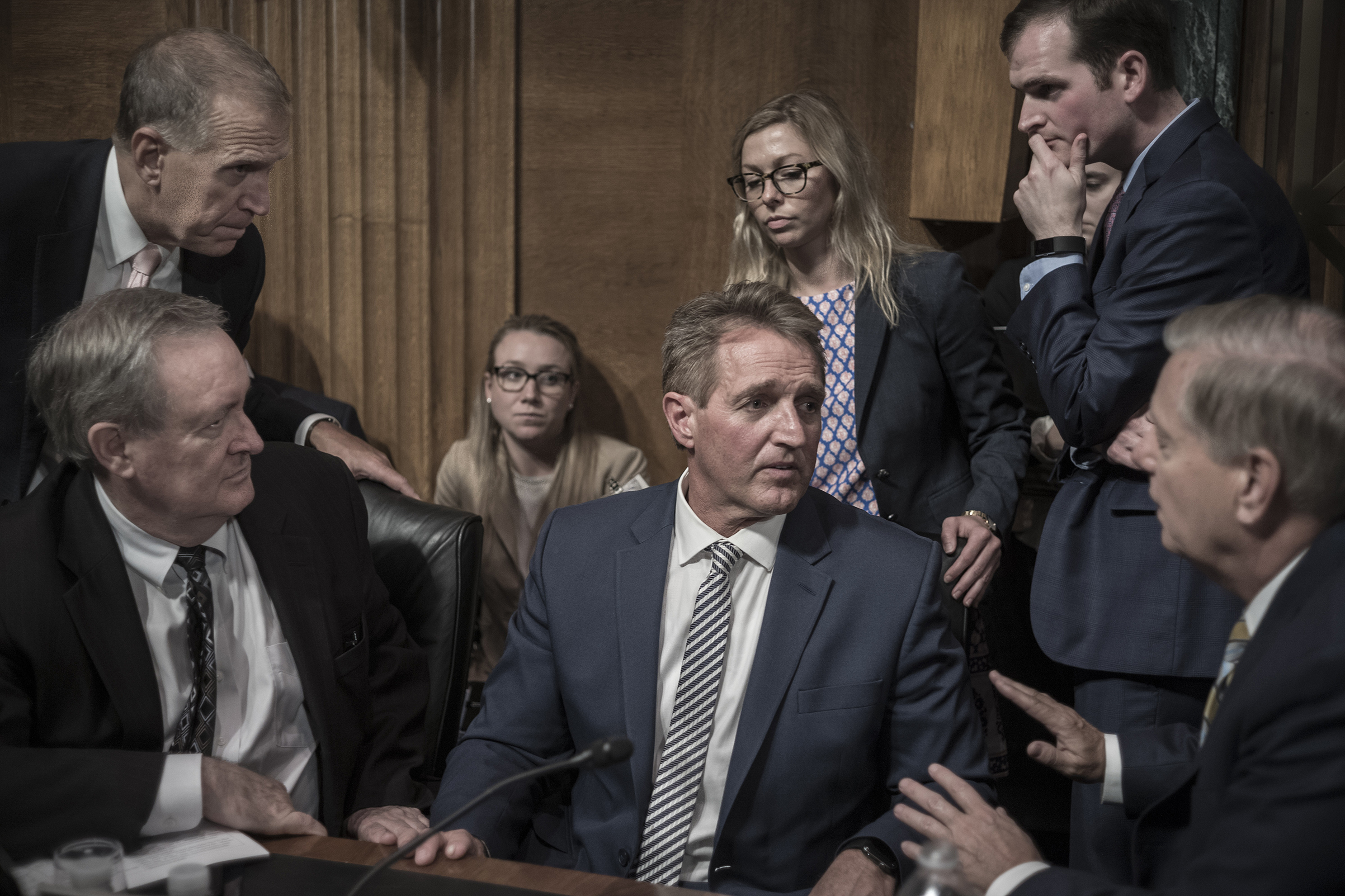GOP Senators surround Senator Jeff Flake, who slowed Kavanaugh’s confirmation after Ford testified