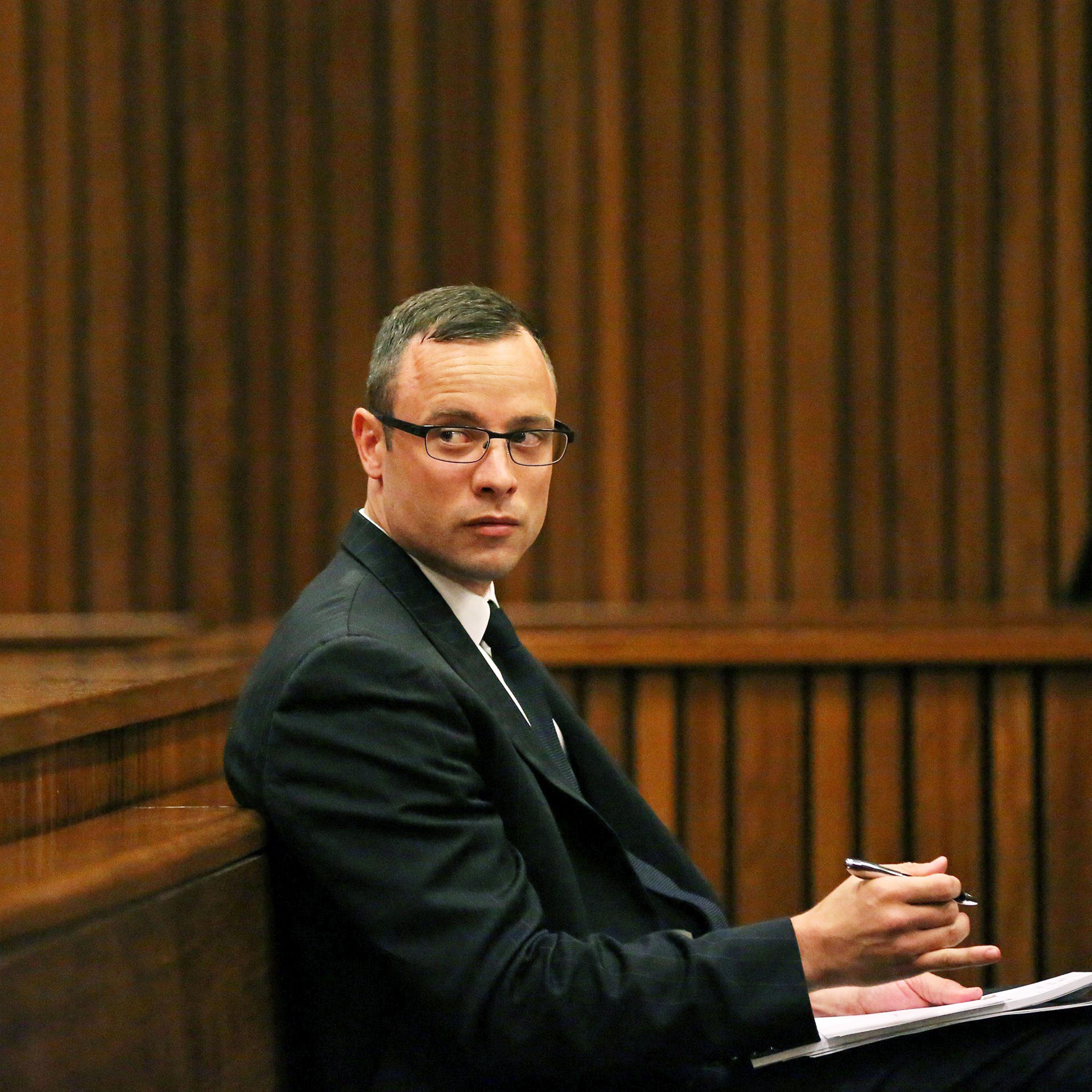Paralympic track star Oscar Pistorius sits in the dock during his trial for the murder of his girlfriend Reeva Steenkamp, at the North Gauteng High Court in Pretoria, on March 25, 2014.