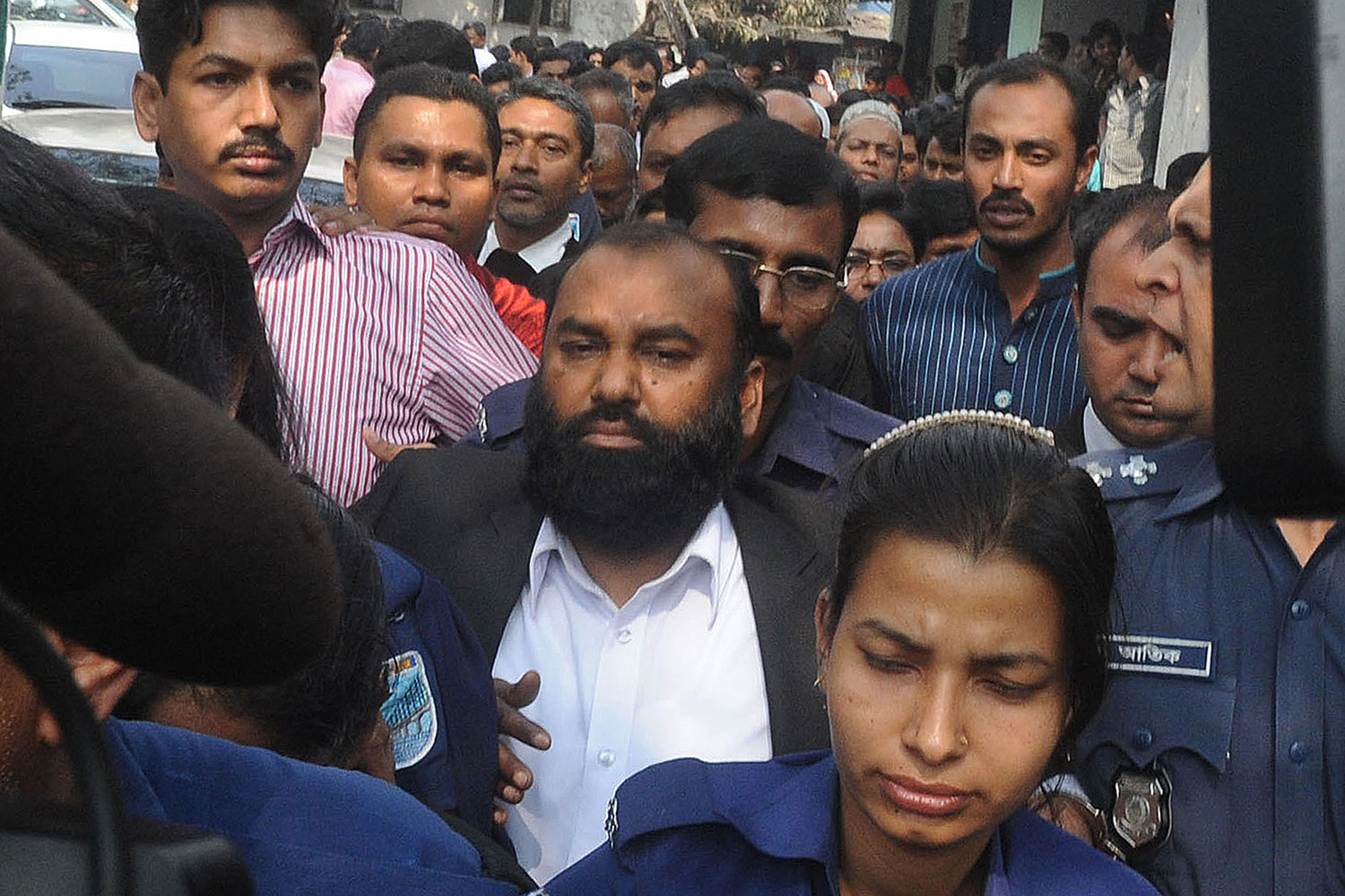 The owner of Tazreen Fashions, Delwar Hossain (C) is escorted to court in Dhaka on Feb. 9, 2014.