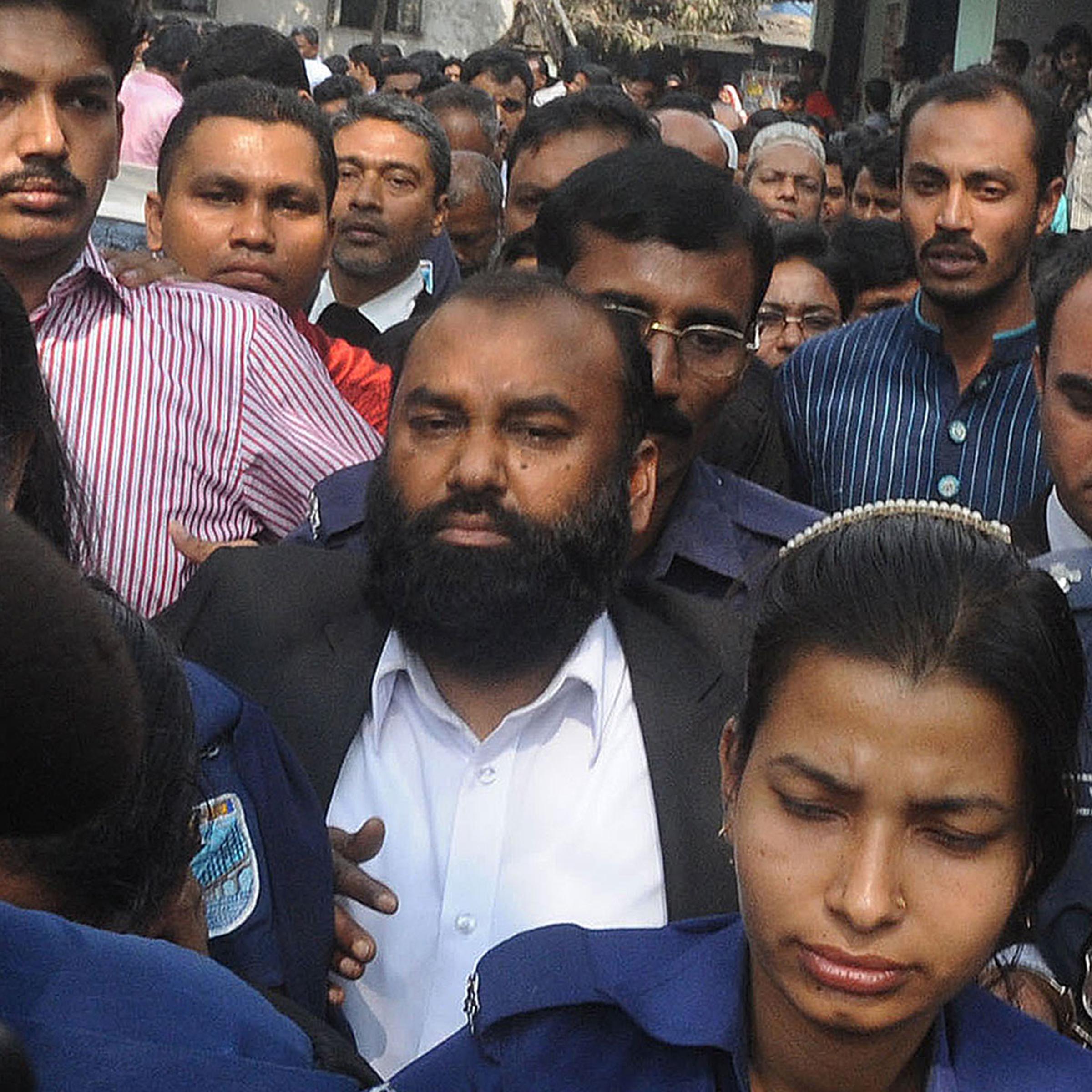 The owner of Tazreen Fashions, Delwar Hossain (C) is escorted to court in Dhaka on Feb. 9, 2014.