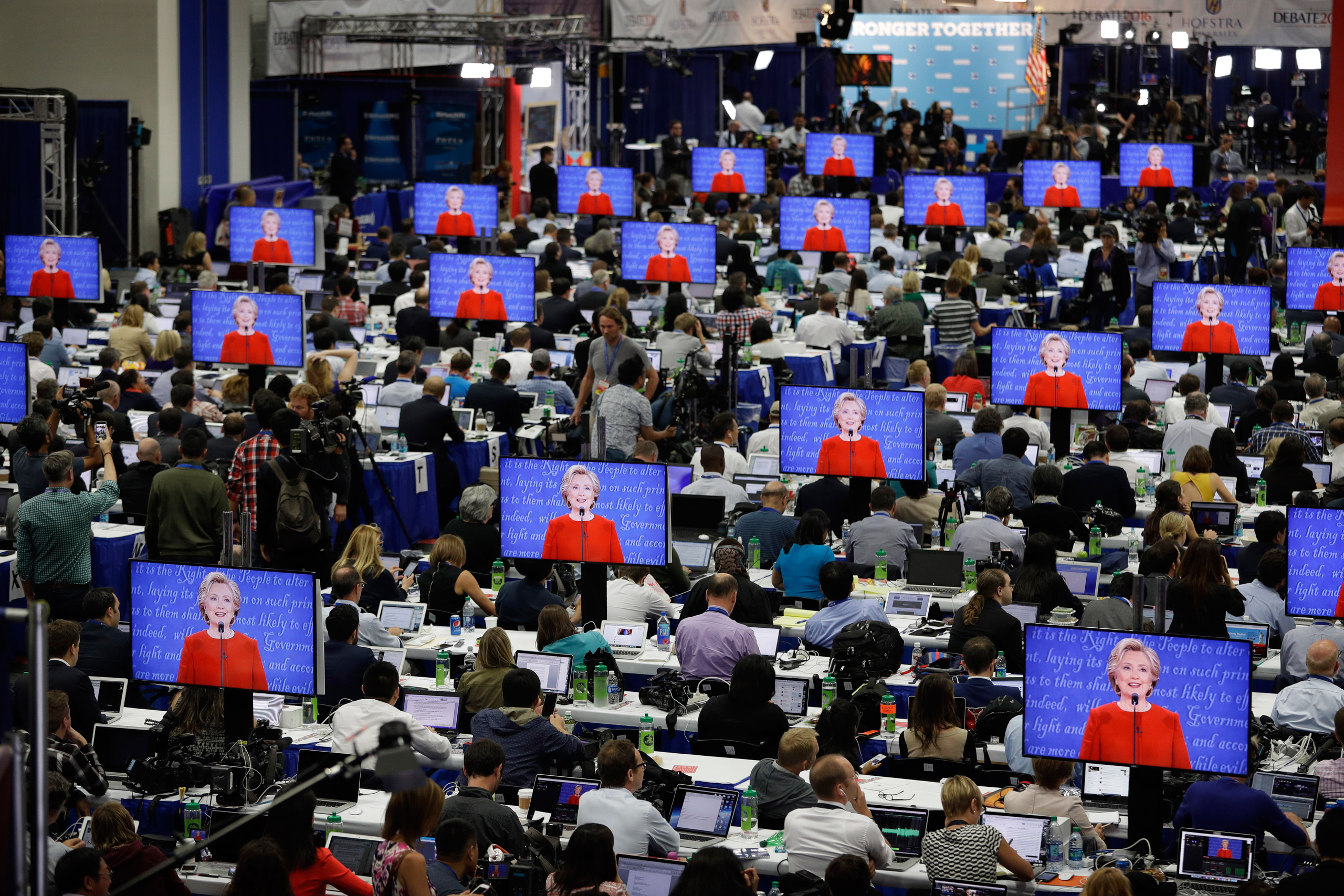 Democratic presidential candidate Hillary Clinton is seen on screens in the media center during the presidential debate between Clinton and Republican presidential candidate Donald Trump at Hofstra University, Monday, Sept. 26, 2016, in Hempstead, N.Y. (