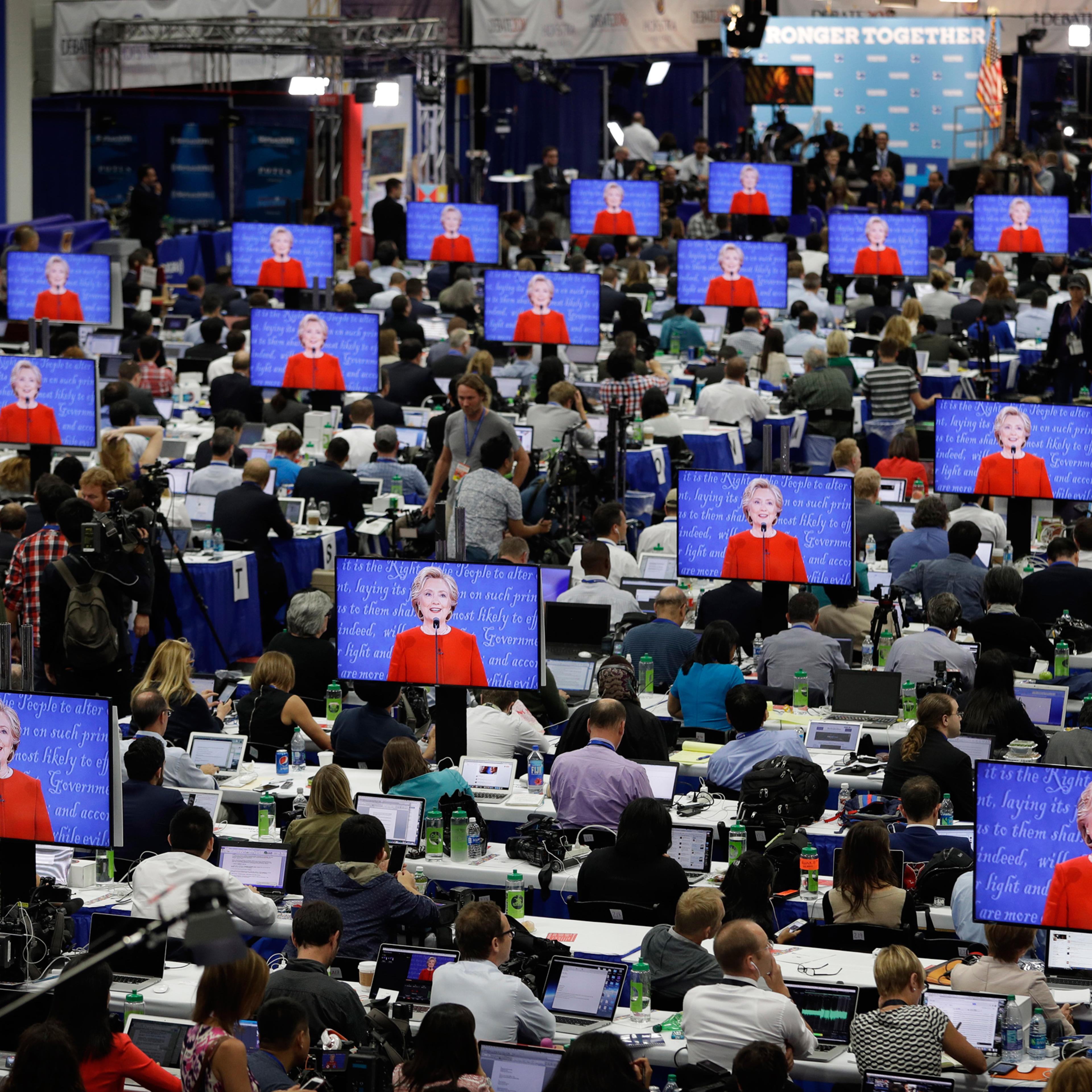 Democratic presidential candidate Hillary Clinton is seen on screens in the media center during the presidential debate between Clinton and Republican presidential candidate Donald Trump at Hofstra University, Monday, Sept. 26, 2016, in Hempstead, N.Y. (