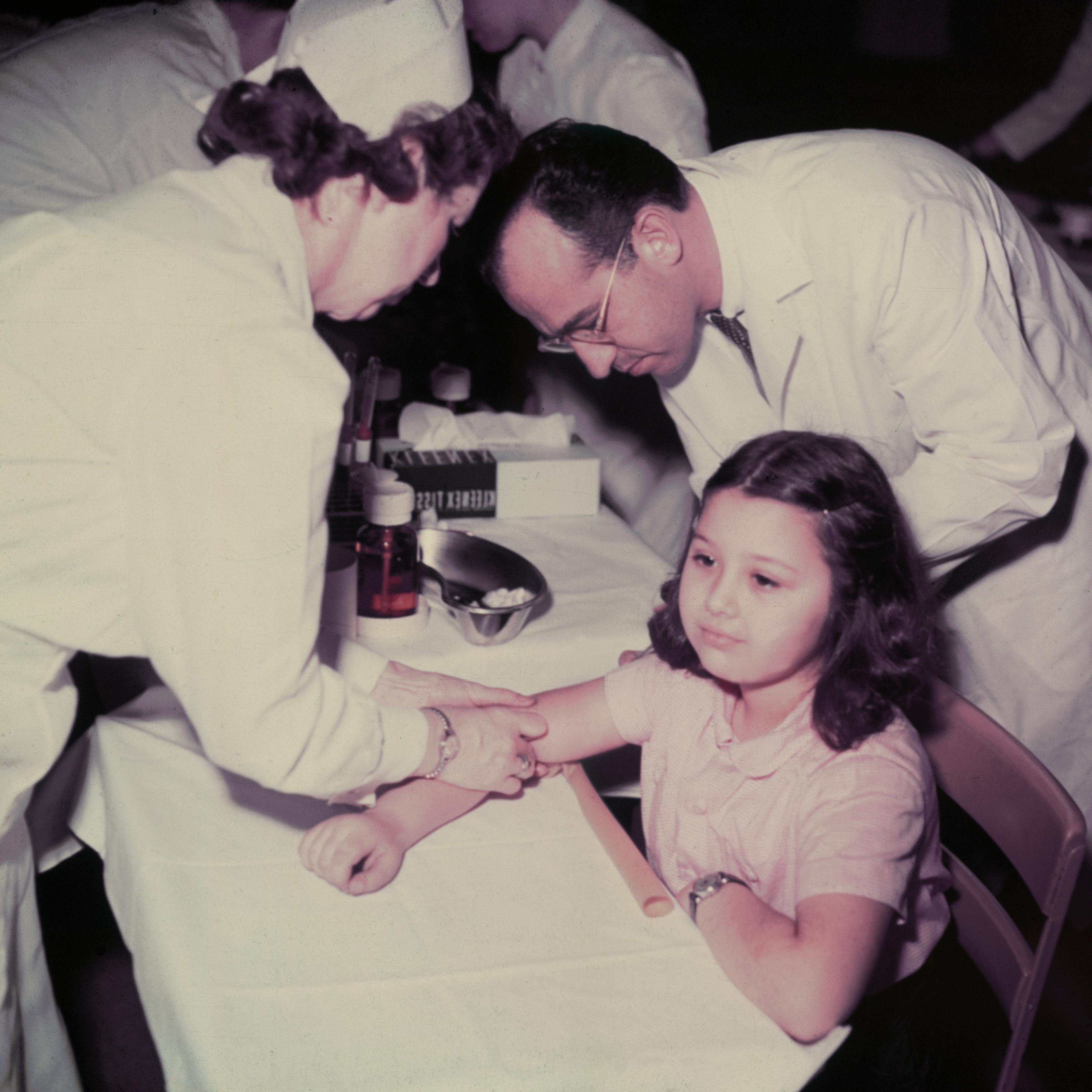 Girl Receiving Polio Vaccine from Jonas Salk