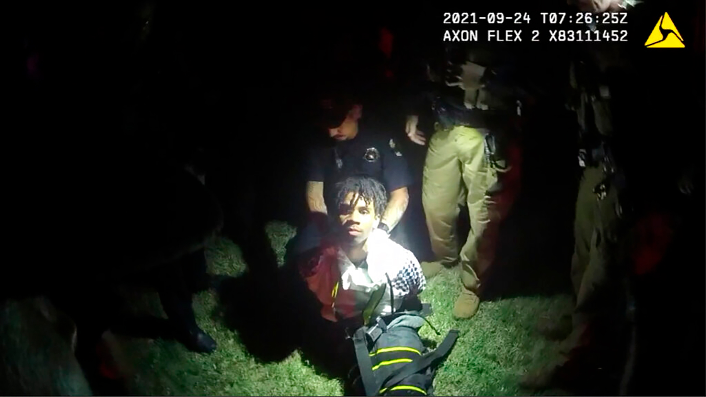 In this image from body camera video provided by Sedgwick County, police put Cedric "C.J." Lofton, 17, into a body-length restraining device called a WRAP outside his home in Wichita, Kan., on Sept. 24, 2021. The death of the Black teenager at a Kansas juvenile detention center was foreshadowed five years earlier by a state inspection of the facility that noted systemic deficiencies in its handling of children with mental health issues, according to a federal civil rights lawsuit filed June 13, 2022. 