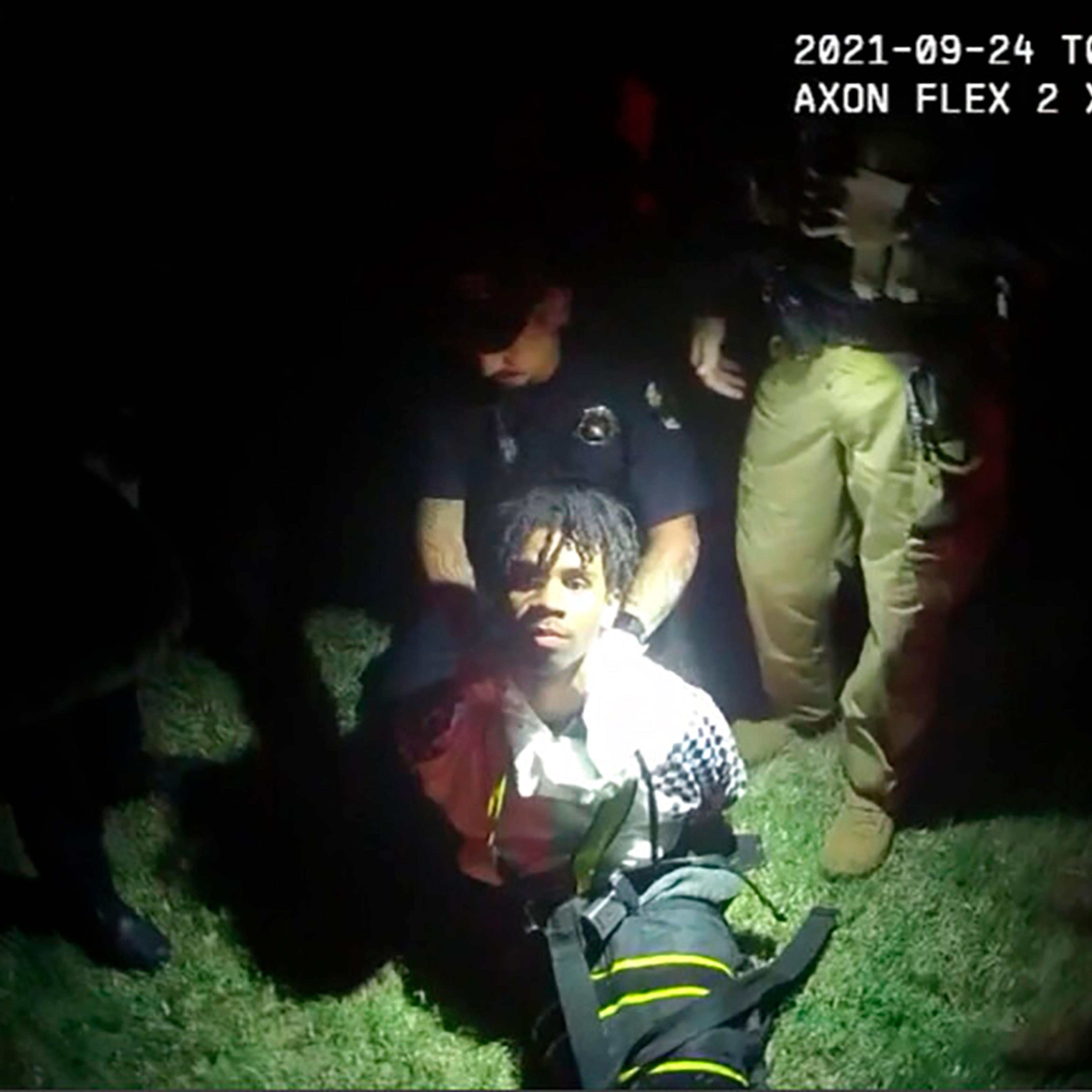 In this image from body camera video provided by Sedgwick County, police put Cedric "C.J." Lofton, 17, into a body-length restraining device called a WRAP outside his home in Wichita, Kan., on Sept. 24, 2021. The death of the Black teenager at a Kansas juvenile detention center was foreshadowed five years earlier by a state inspection of the facility that noted systemic deficiencies in its handling of children with mental health issues, according to a federal civil rights lawsuit filed June 13, 2022.