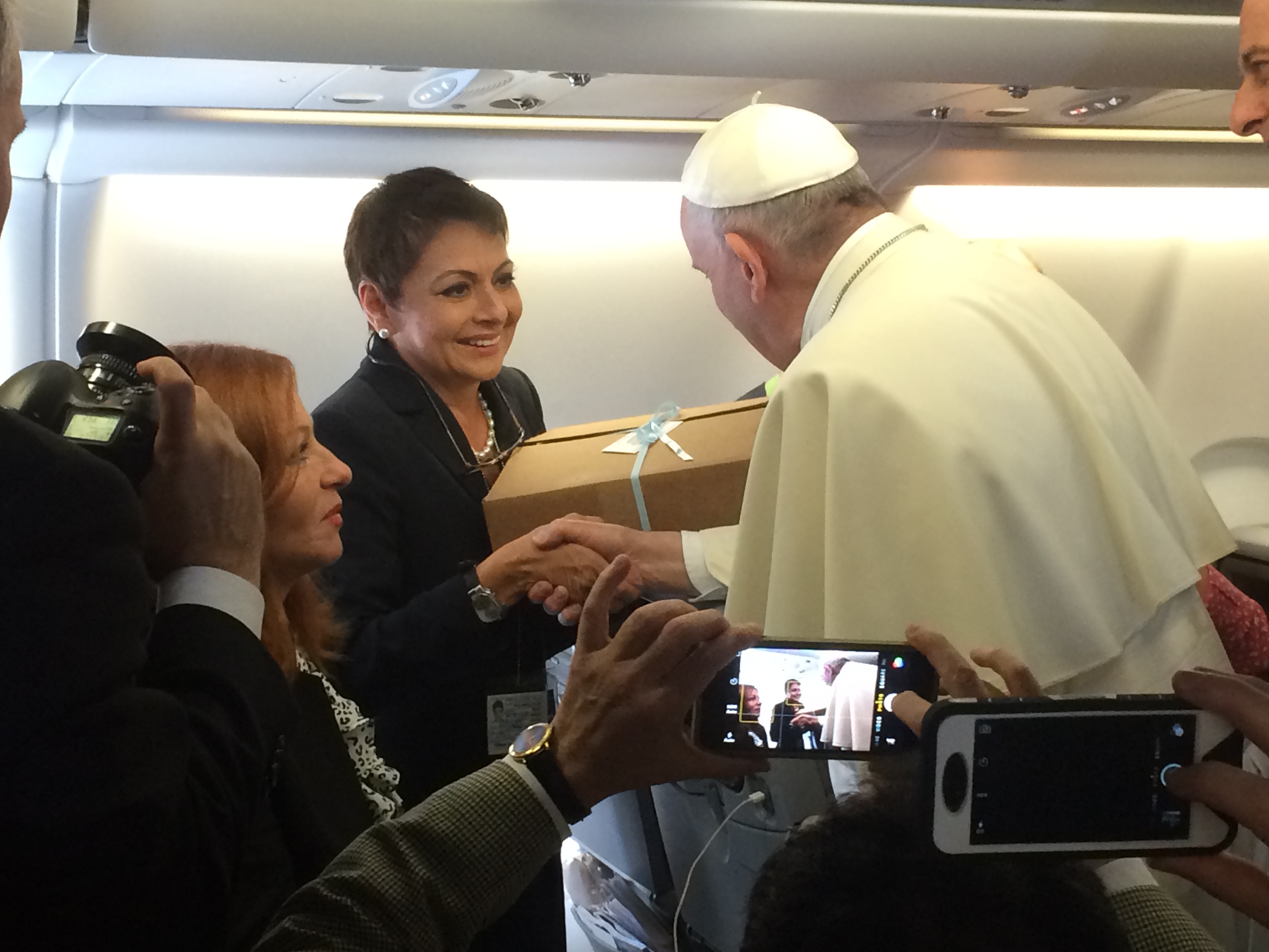 Univision correspondent Maria Antonieta Collins gives Argentinian empanadas to Pope Francis aboard the papal flight from Rome to Havana.