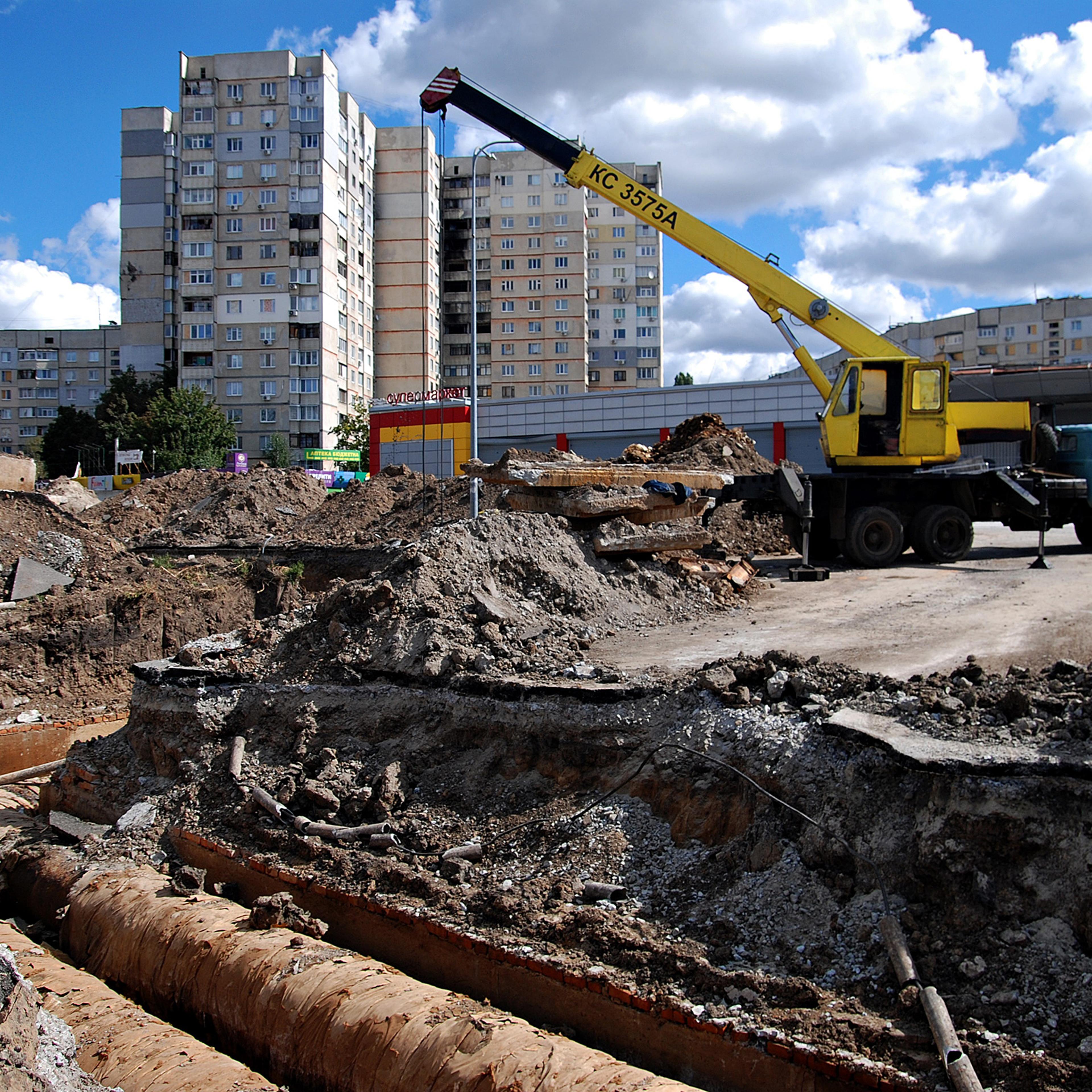 The truck crane stands next to the section of the heating main where utility workers replace old pipes on Sept. 9 in Kharkiv, Ukraine. The city authorities organized the replacement of heating pipes to reduce heat losses in the Saltivka district, despite daily shelling by Russian troops.