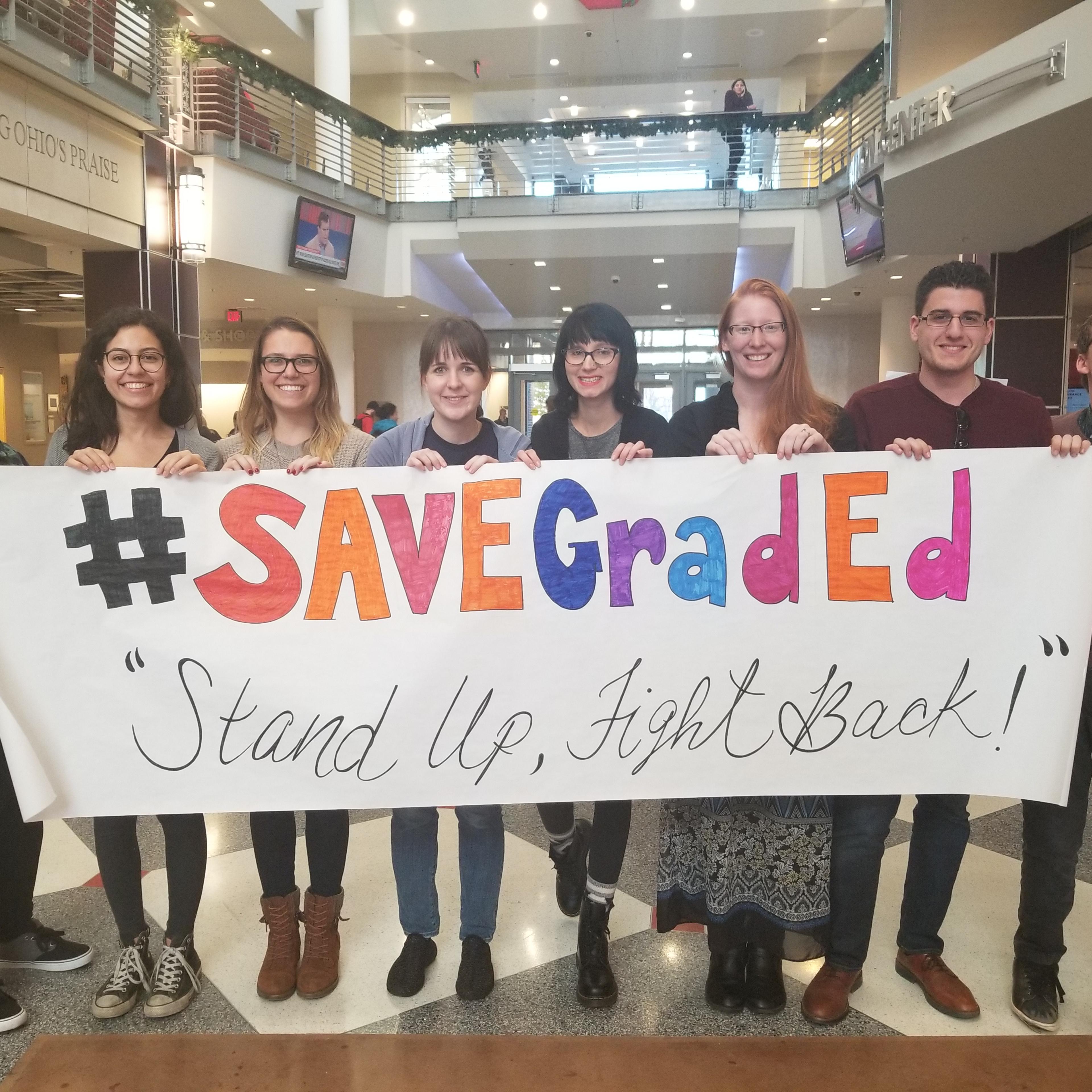 (From left to right) Graduate students Misha Grifka, Natalia Colon Alvarez, Alison Cummins, Mariah Marsden, Liz Miller, Paige Busby, Yanar Hashlamon and Noah Bukowski protest the GOP tax bill at Ohio State University on Nov. 29, 2017.