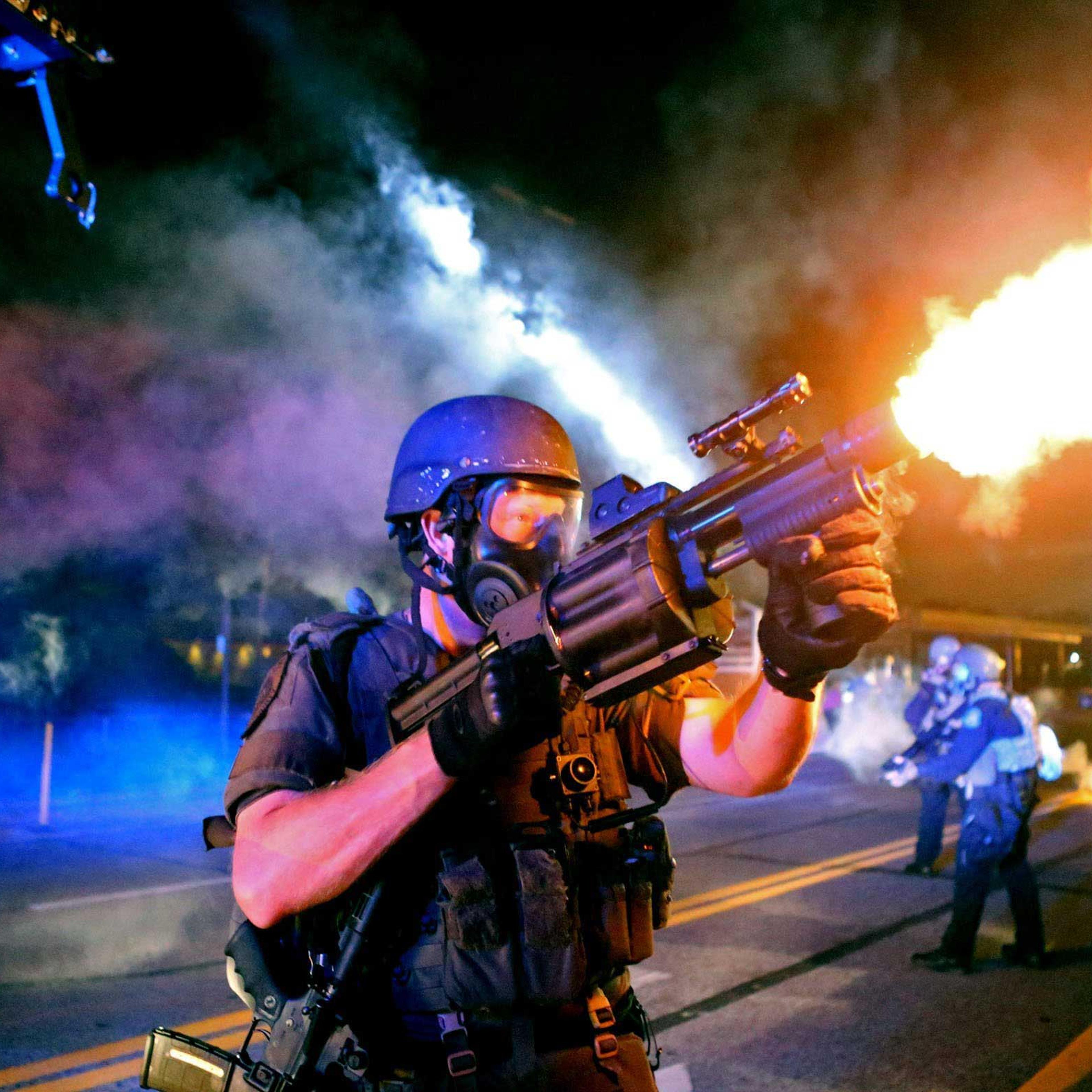 Aug. 18, 2014. Police fire tear gas in the direction of where bottles were thrown from crowds gathered near the QuikTrip on W. Florissant Avenue.