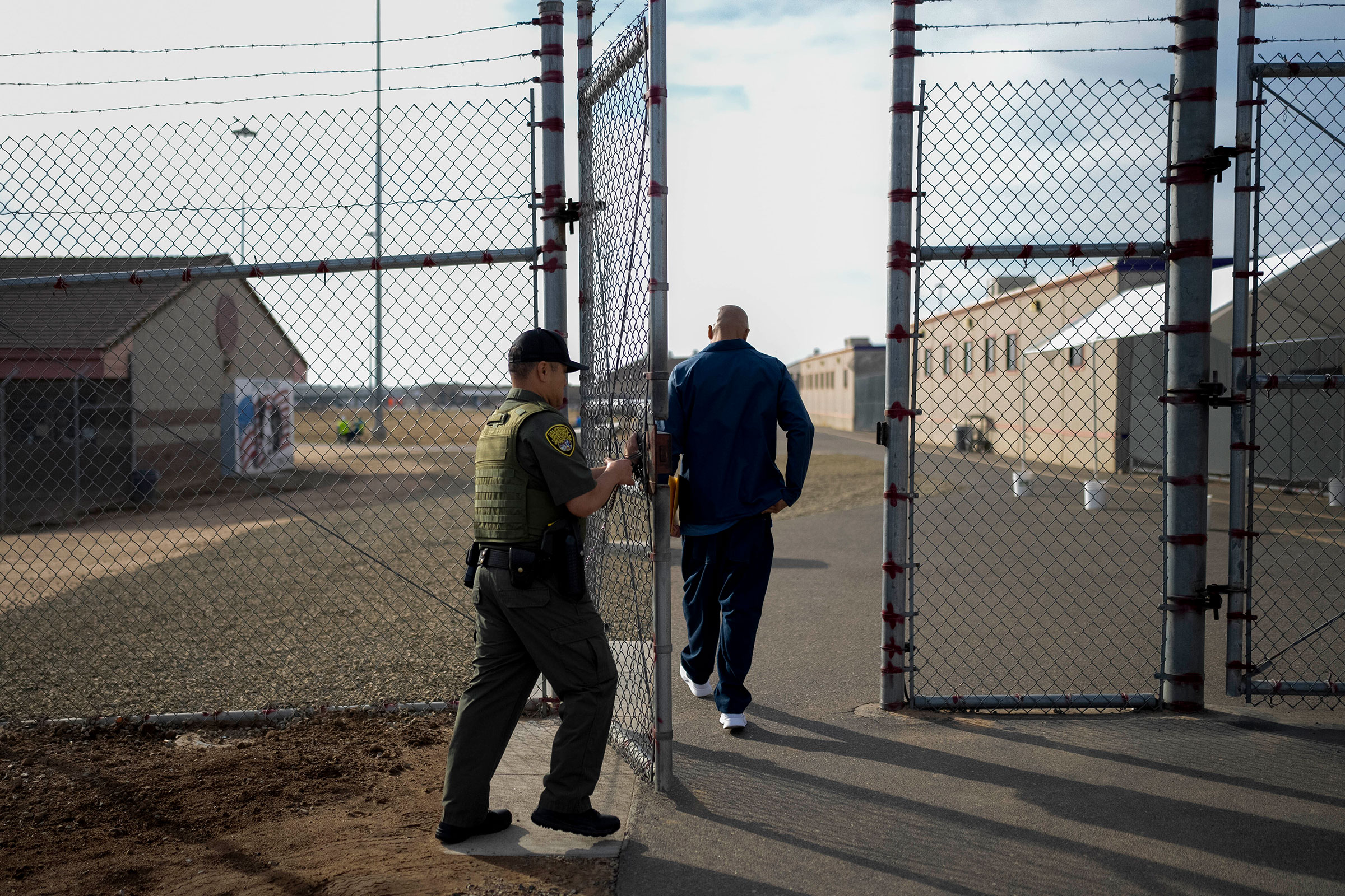 Officer Jimmy Bliatout closes a gate after a prisoner enters the yard at Valley State Prison in Chowchilla, Calif., Friday, Nov. 4, 2022.