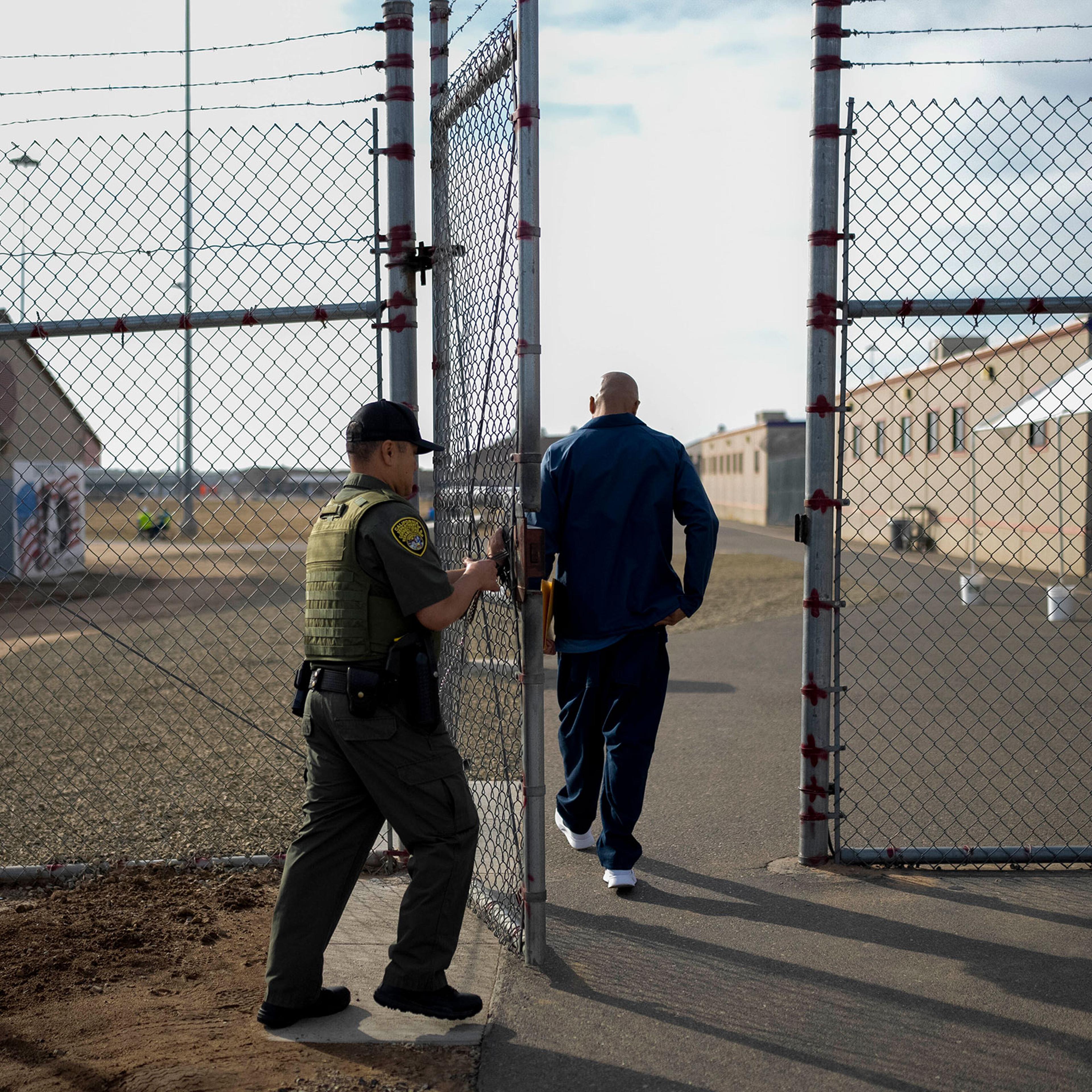 Officer Jimmy Bliatout closes a gate after a prisoner enters the yard at Valley State Prison in Chowchilla, Calif., Friday, Nov. 4, 2022.