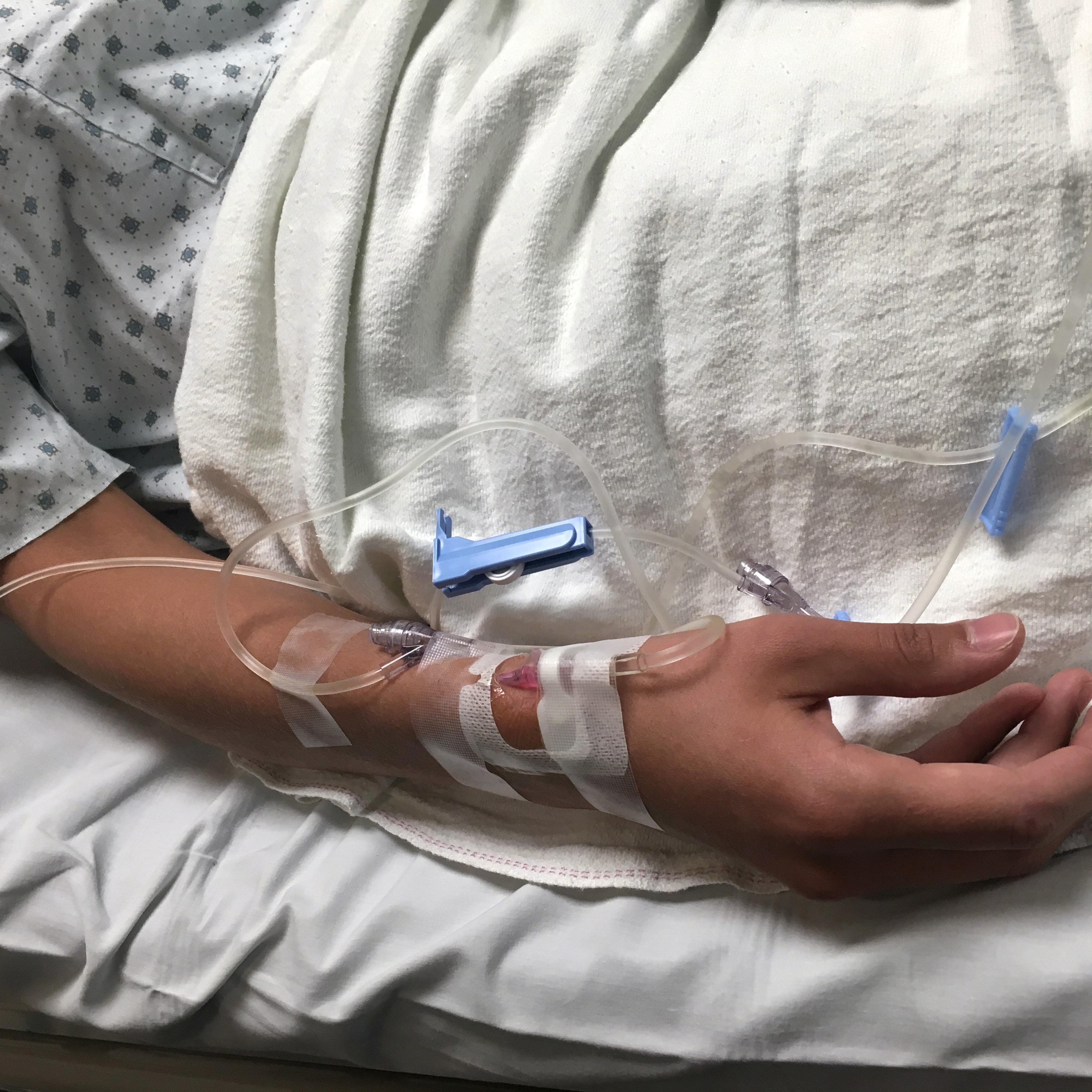 Patient in Hospital bed with IV in arm